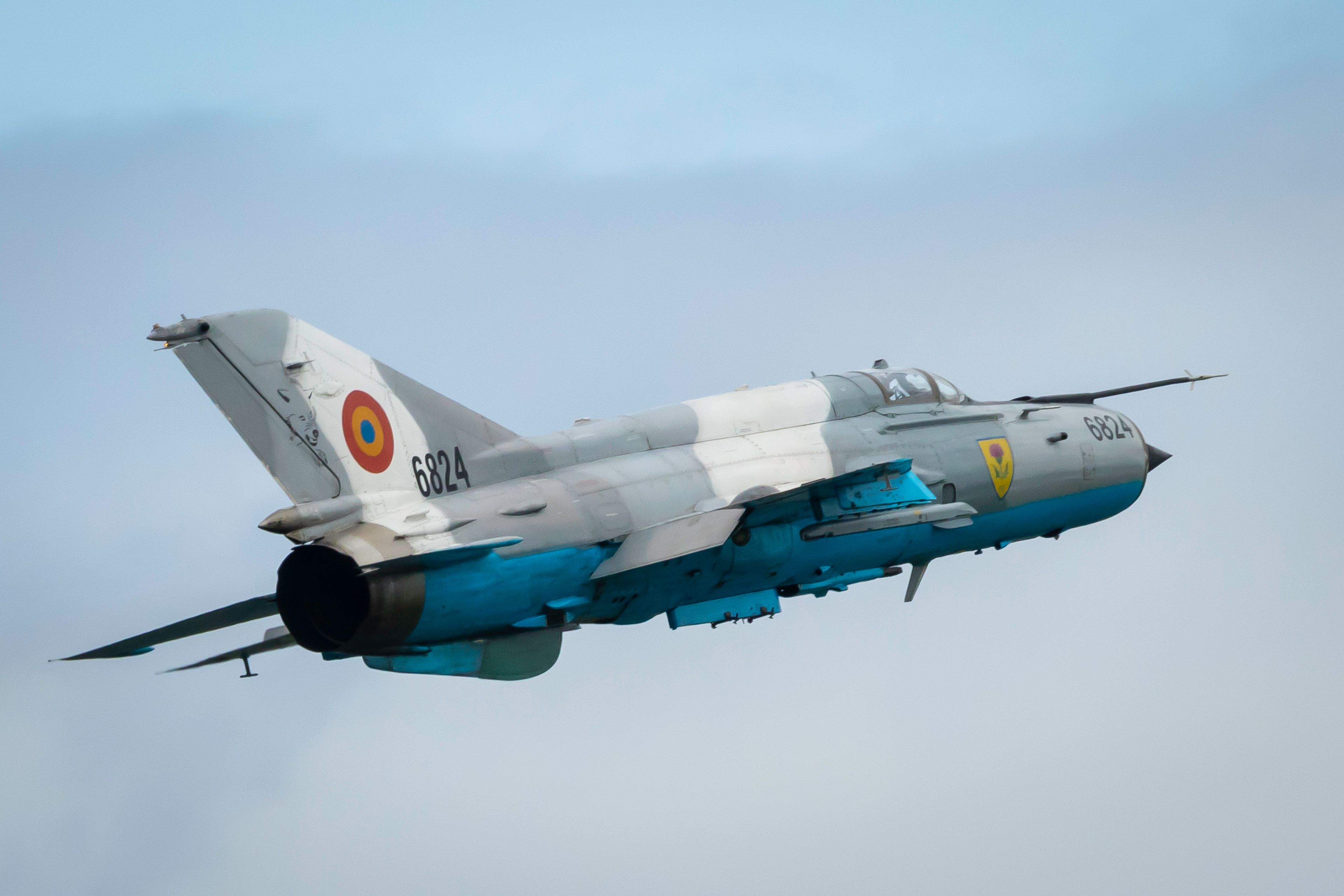 An Ex-Russian Soviet Cold War Romanian MiG-21 Fishbed flying in the sky.