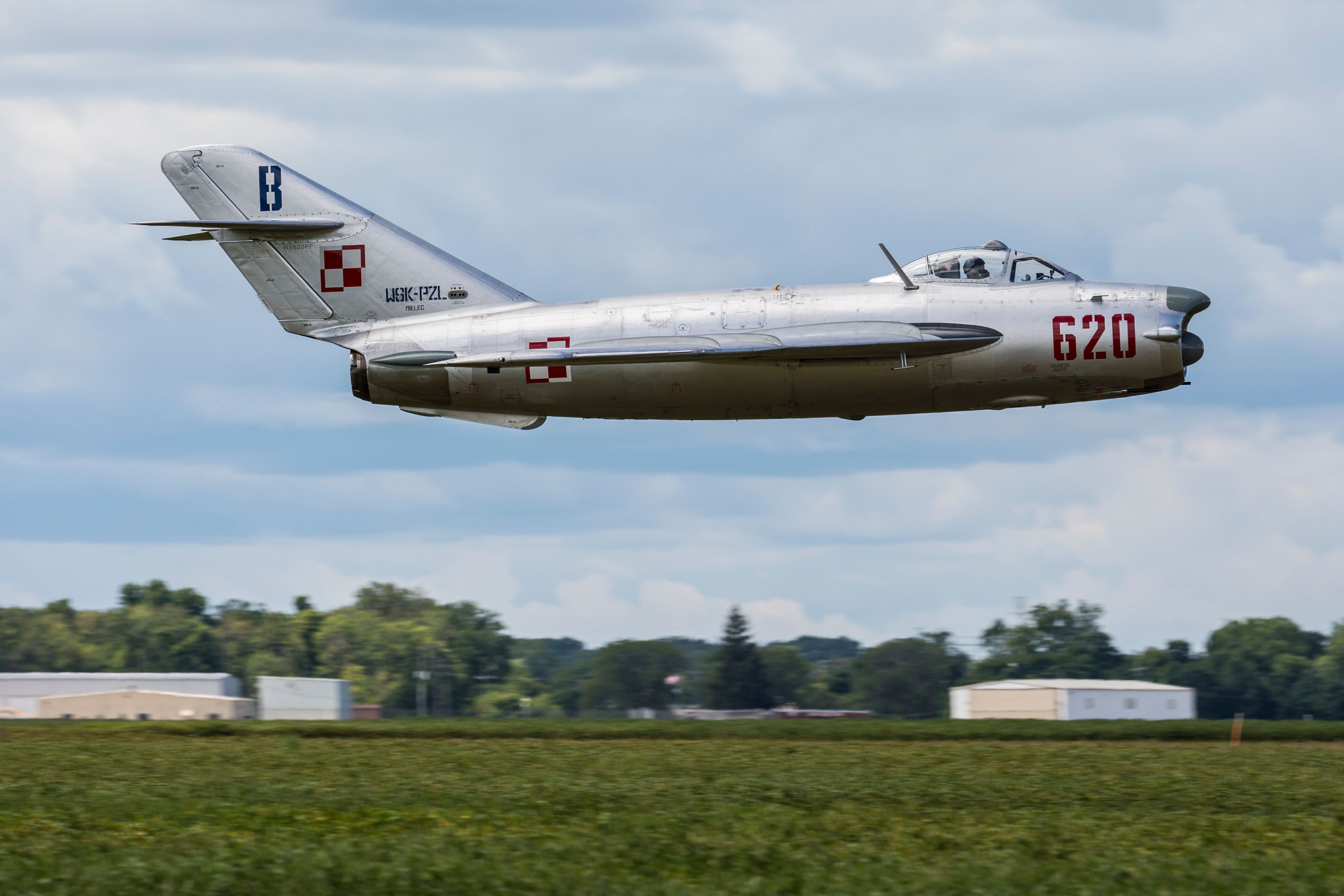 A MiG-15 flying close to the ground.