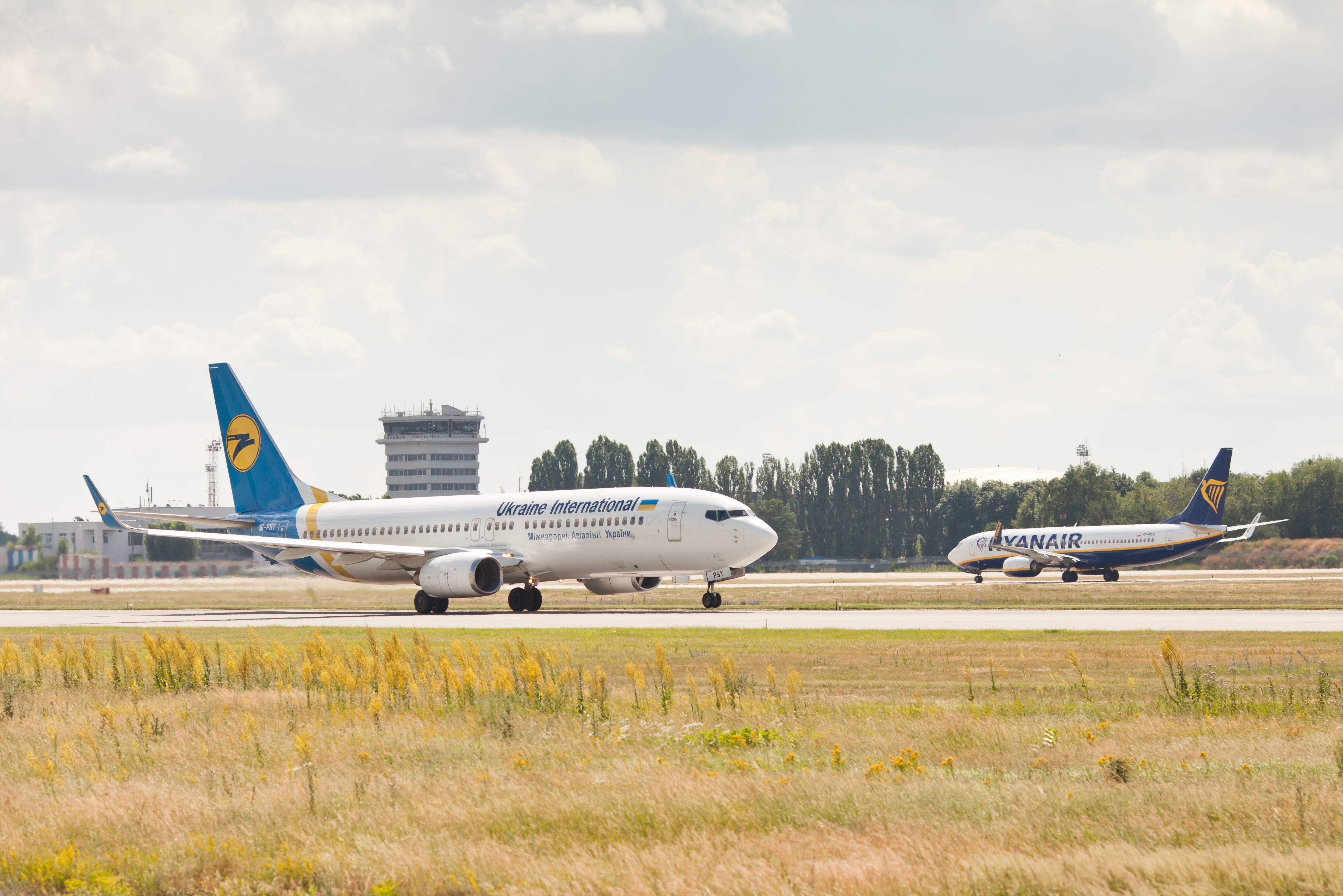 Kyiv, Ukraine - 10 JUL 2021: Boeing 737 of Ryanair and UIA on the runway and taxiway of Boryspil airport.