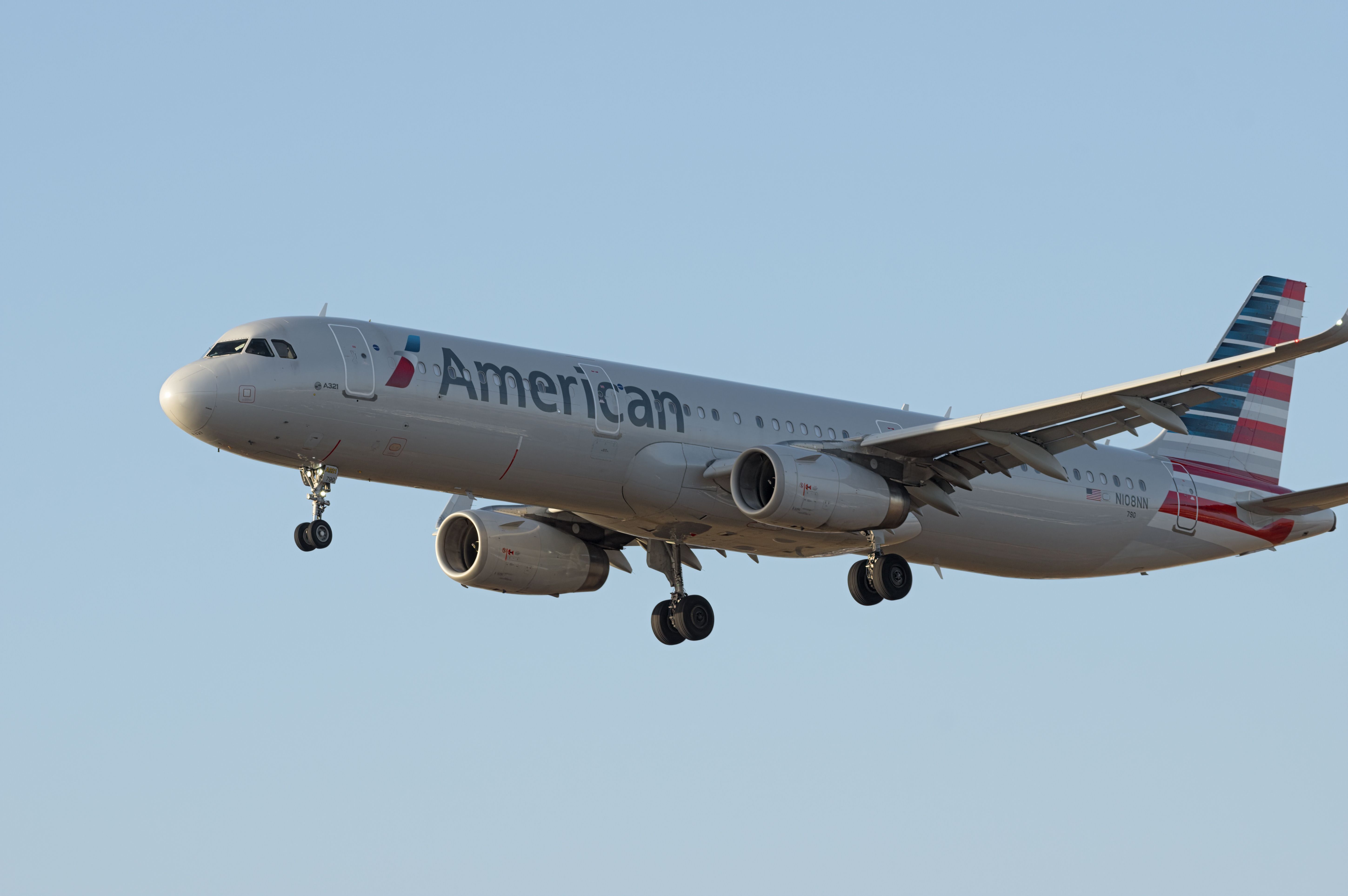 An American Airlines Airbus A321-231 flying in the sky.