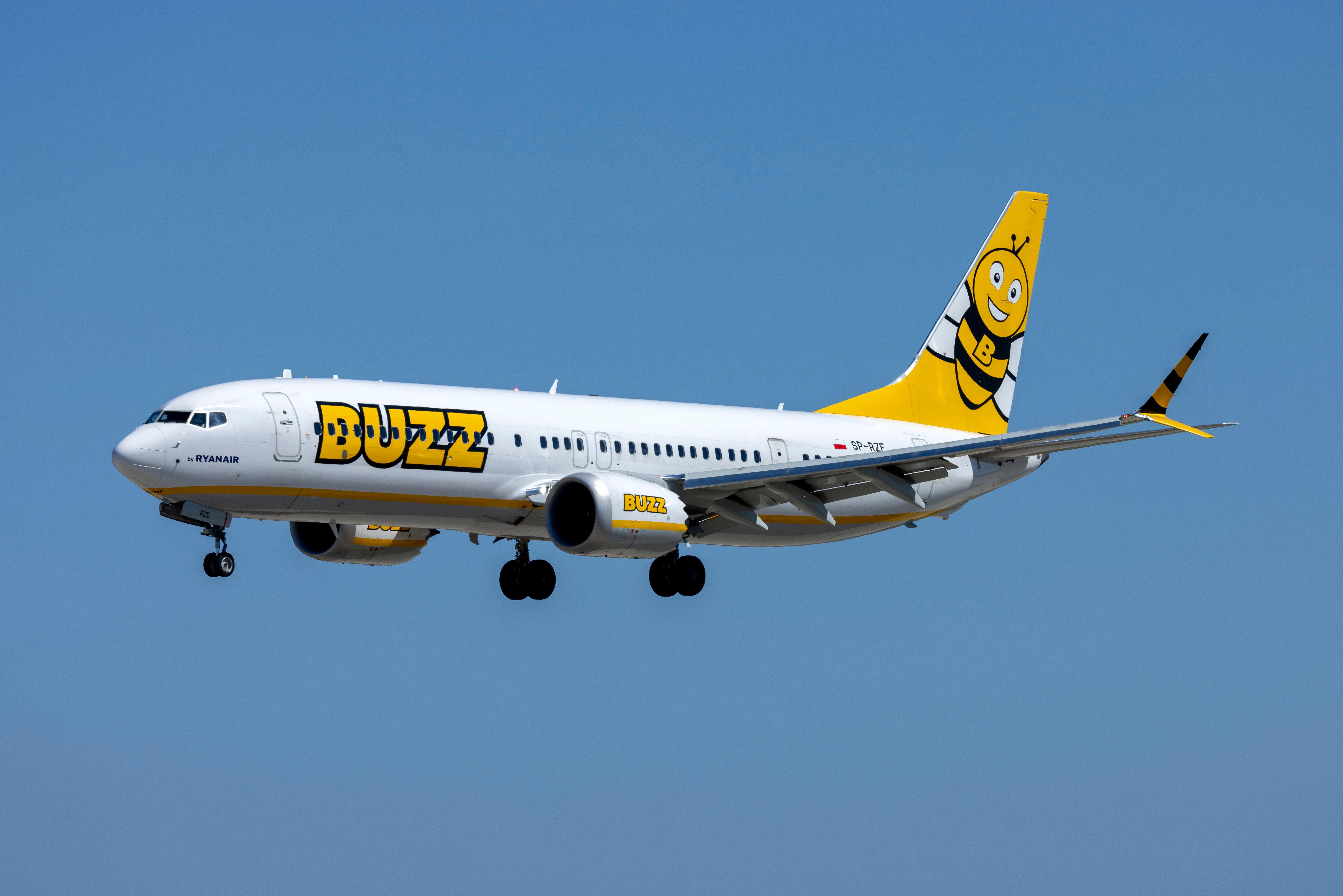A Buzz Boeing 737 MAX flying in the sky.