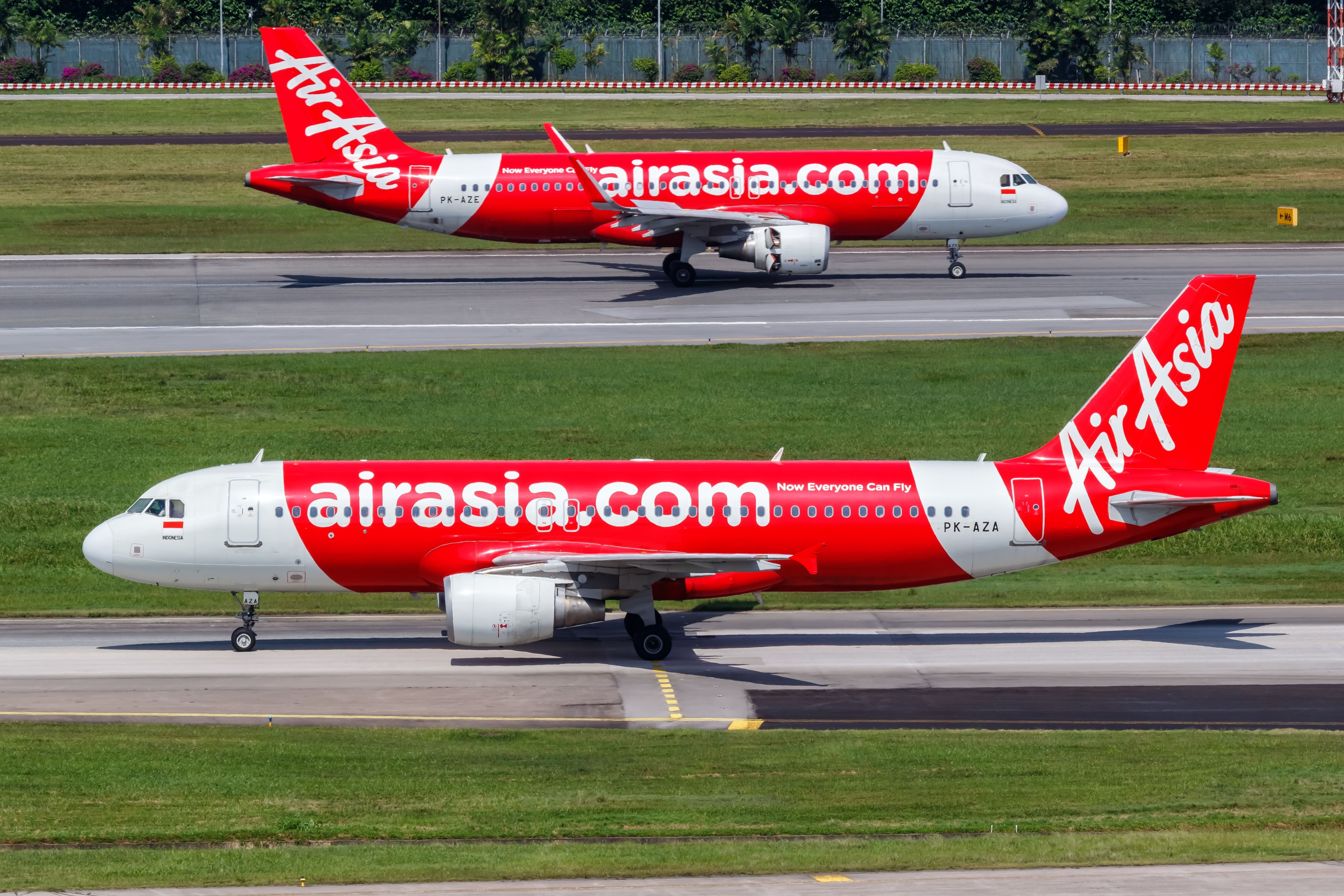Indonesia AirAsia Airbus A320 airplanes at Changi Airport (SIN) in Singapore