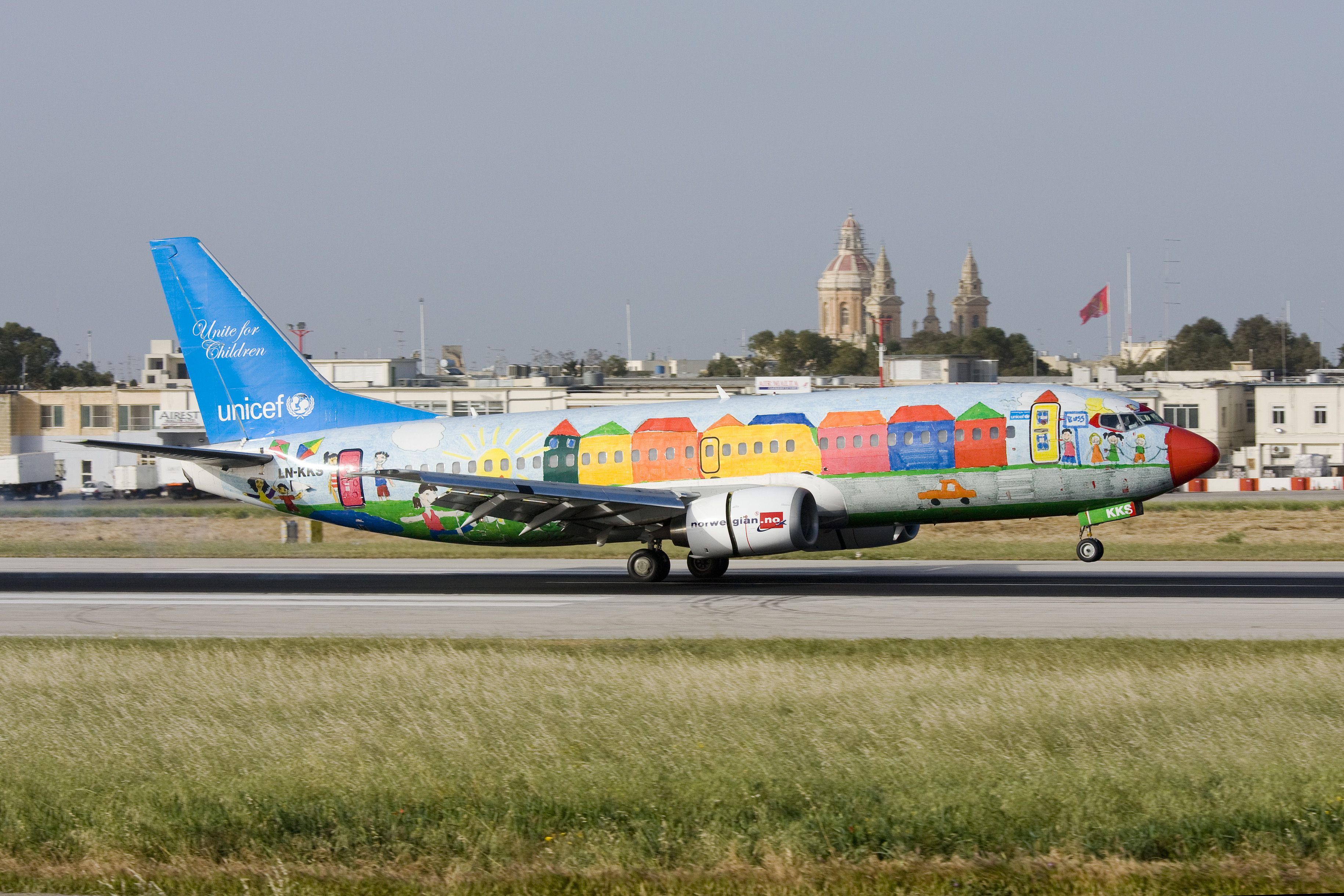 A Norwegian aircraft in UNICEF livery taking off.
