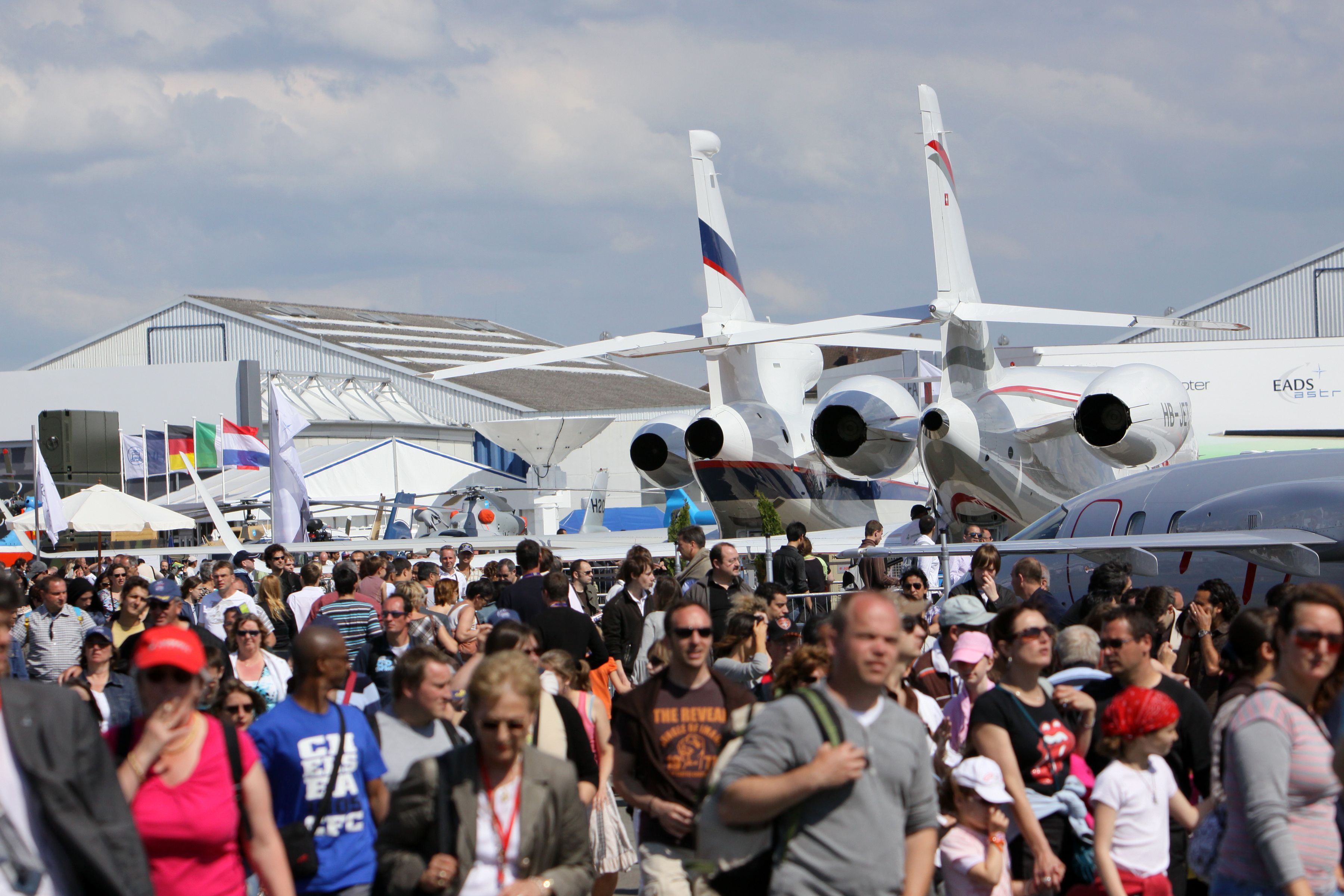 Many people and aircraft at the Paris Air Show.
