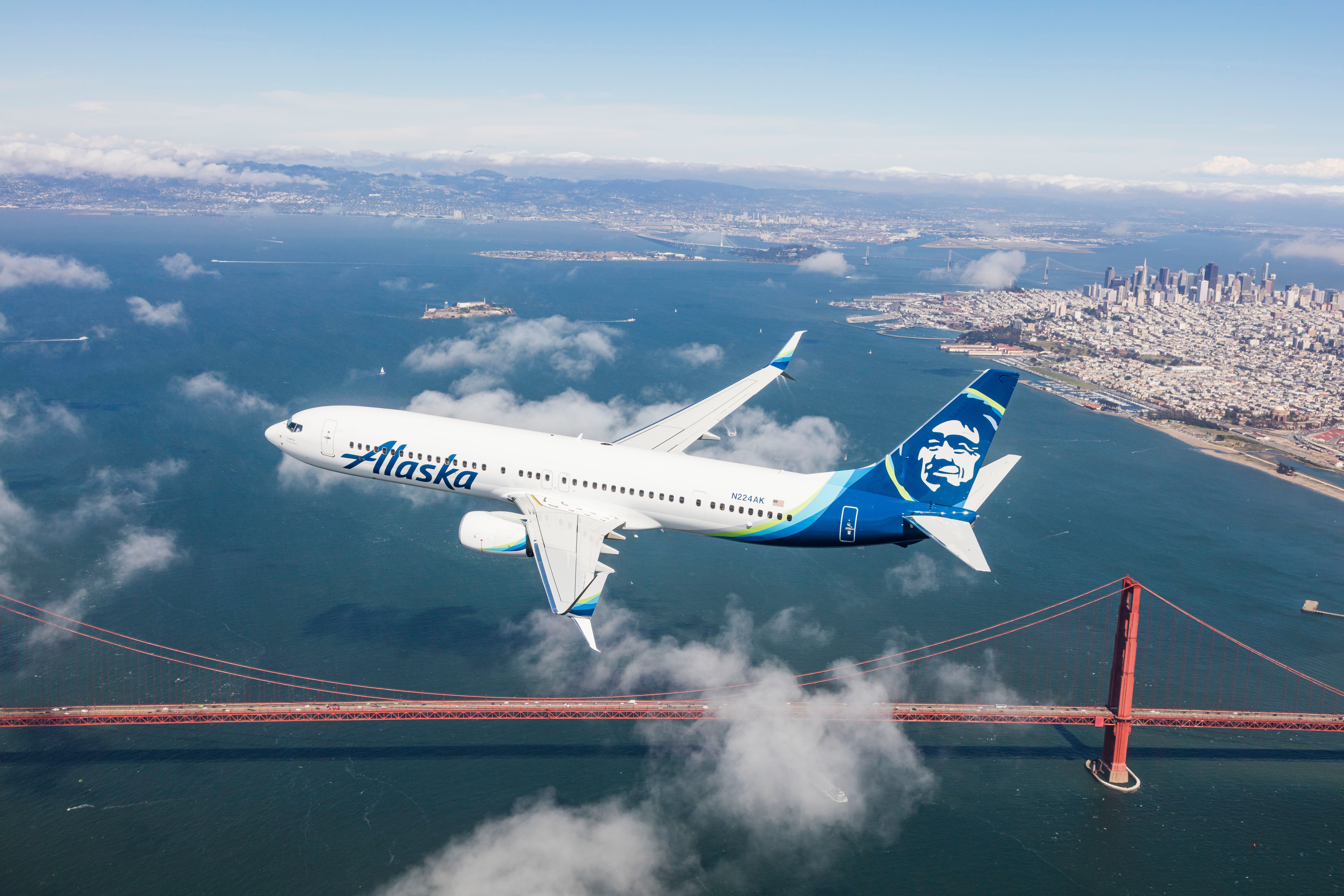 White Boeing 737 with Alaska Airlines livery flies over the Golden Gate Bridge in San Francisco