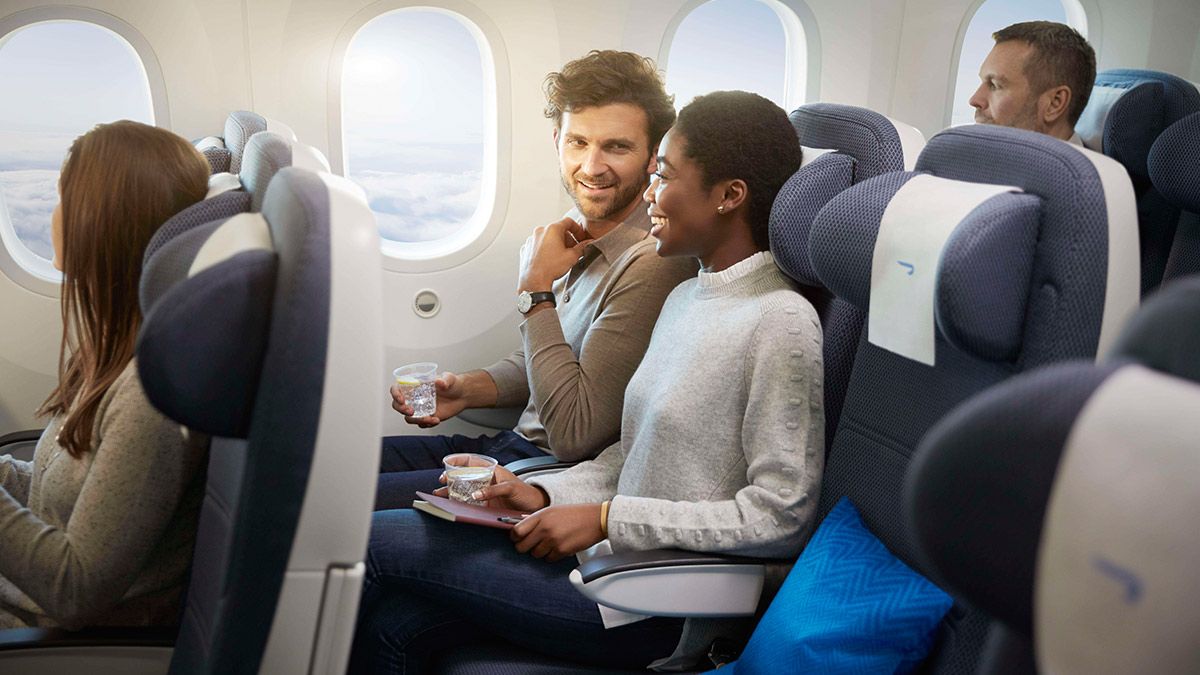 Passengers sitting in the British Airways World Traveller Cabin.