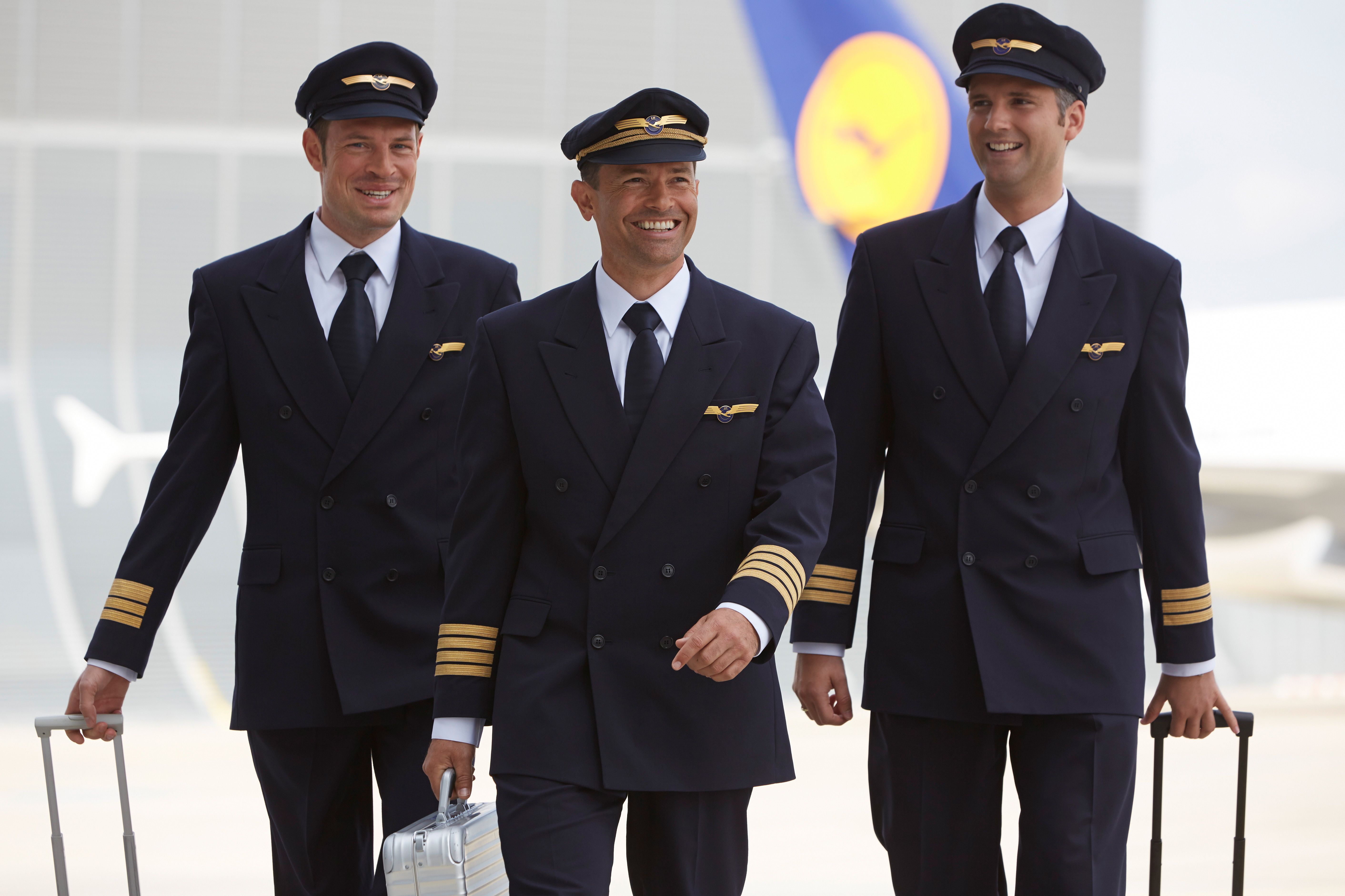 Multiple Lufthansa pilots walking together..