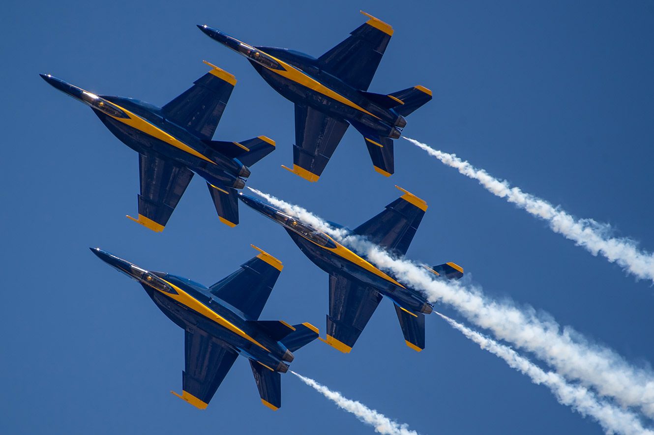 Four Blue Angels fighter jets in formation.