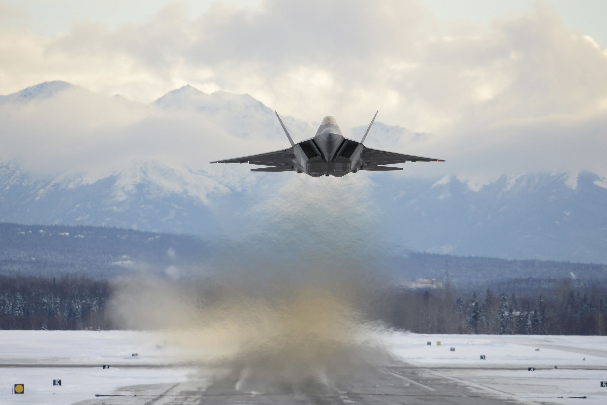 An F-22 flying over Joint Base Elmendorf-Richardson in Alaska.