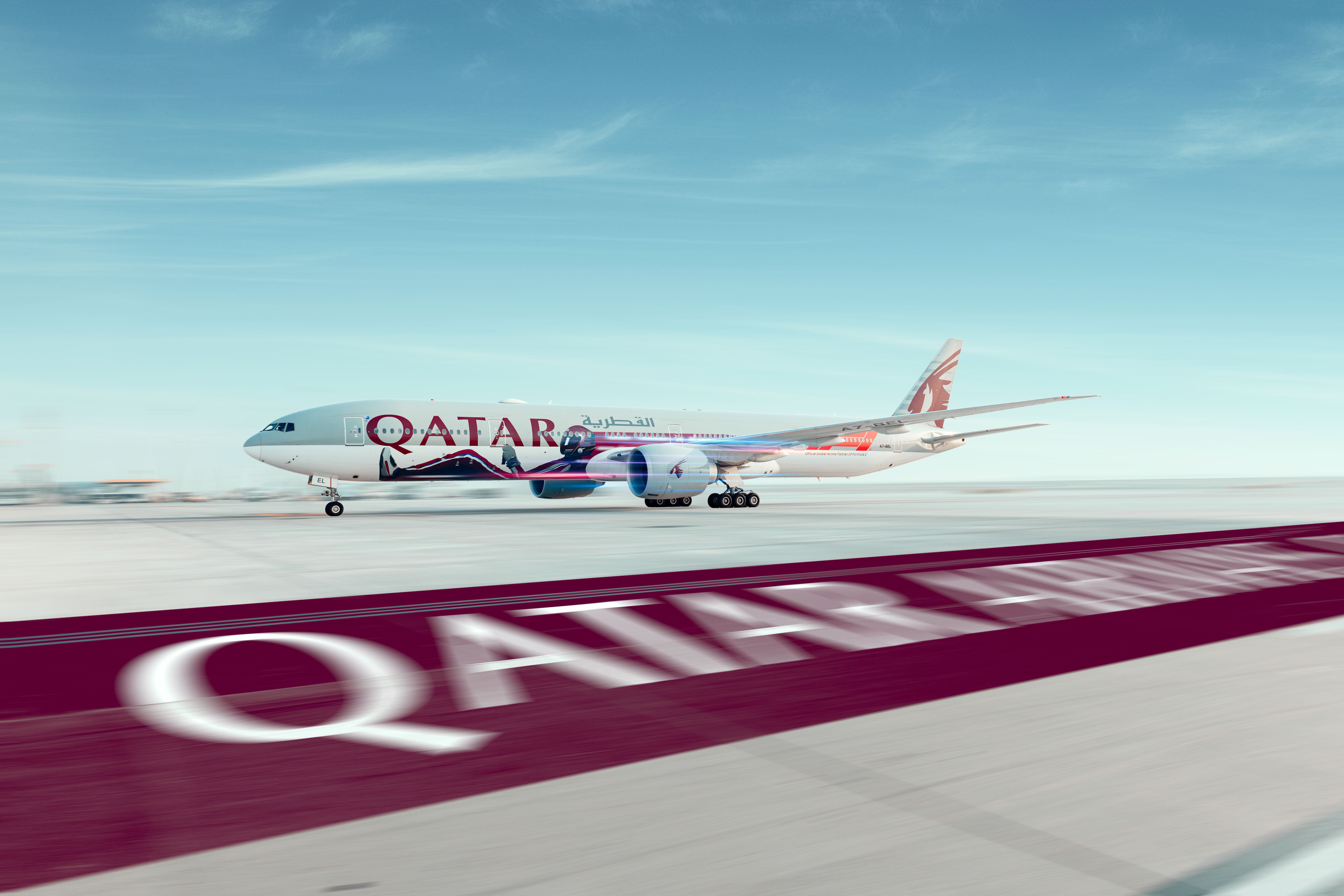 Qatar Airways aircraft in F1 colors parked at the airport.