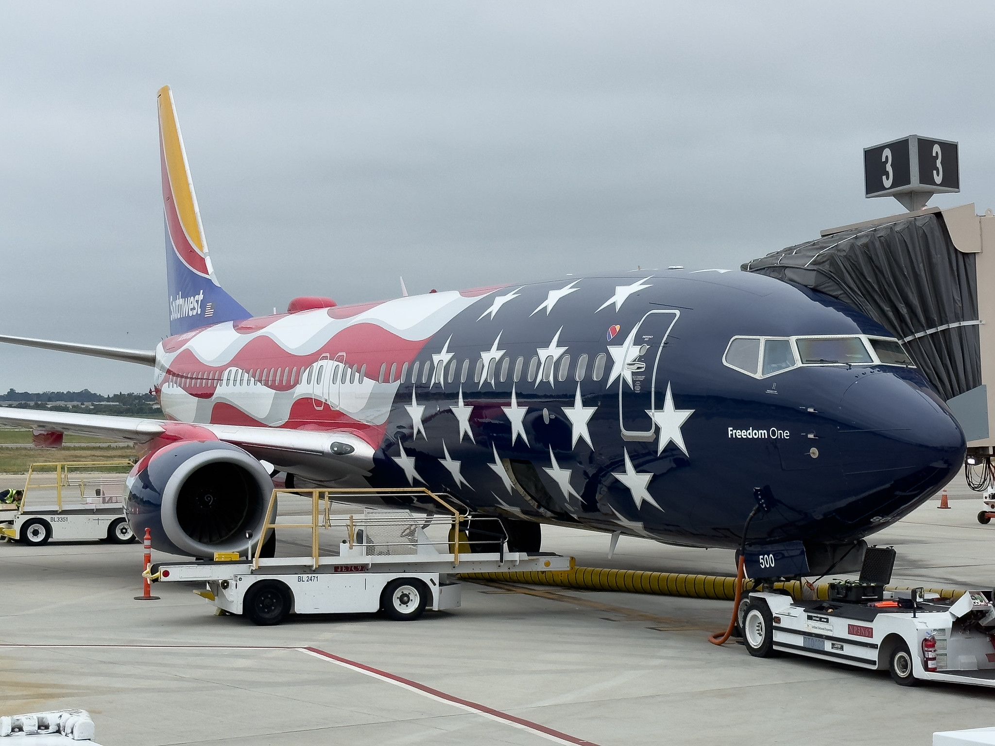 A Southwest Airlines aircraft painted in Freedom One livery parked at the gate.