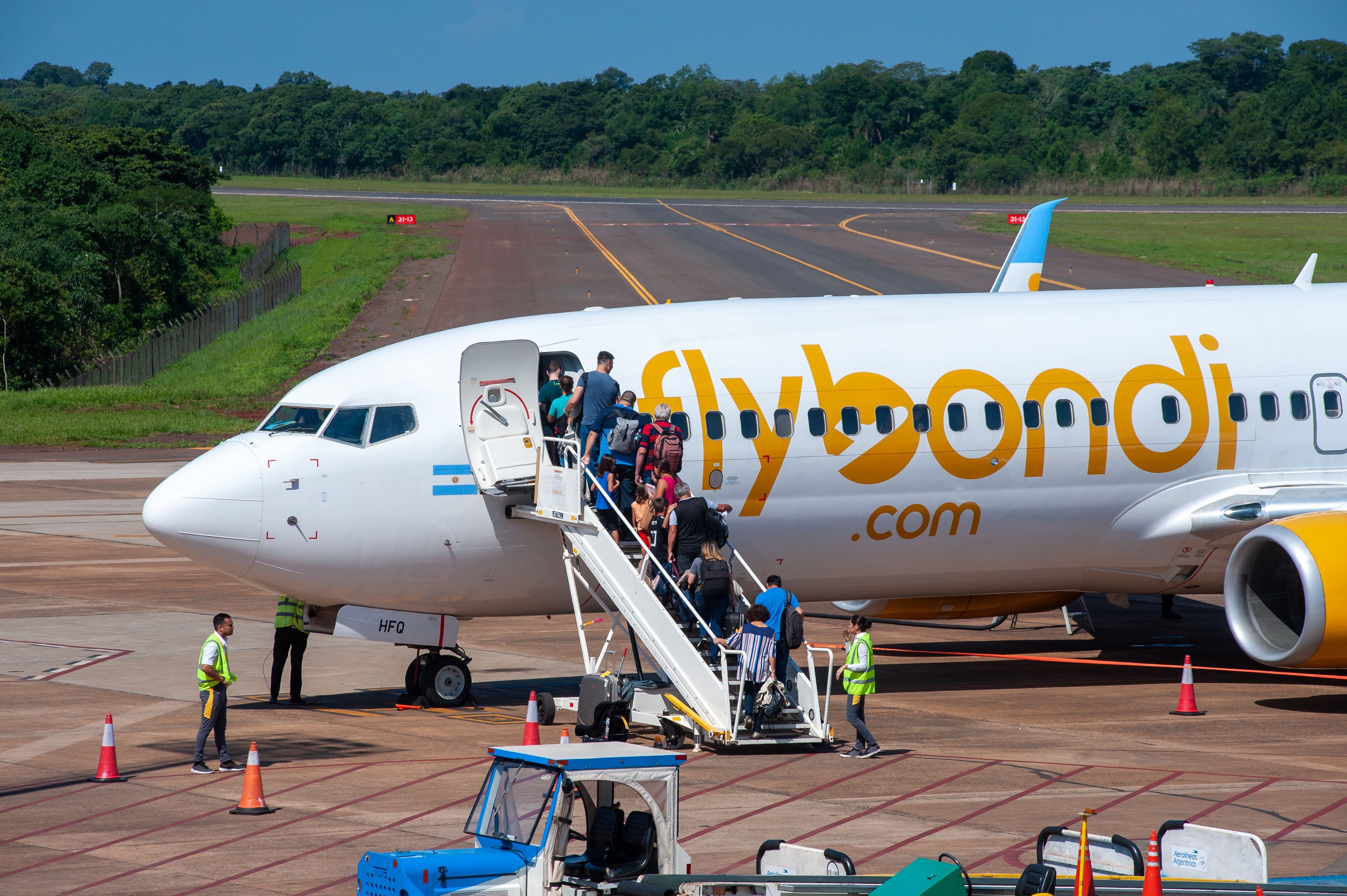 A Flybondi Boeing 737-800 on the ground from which passengers are descending 