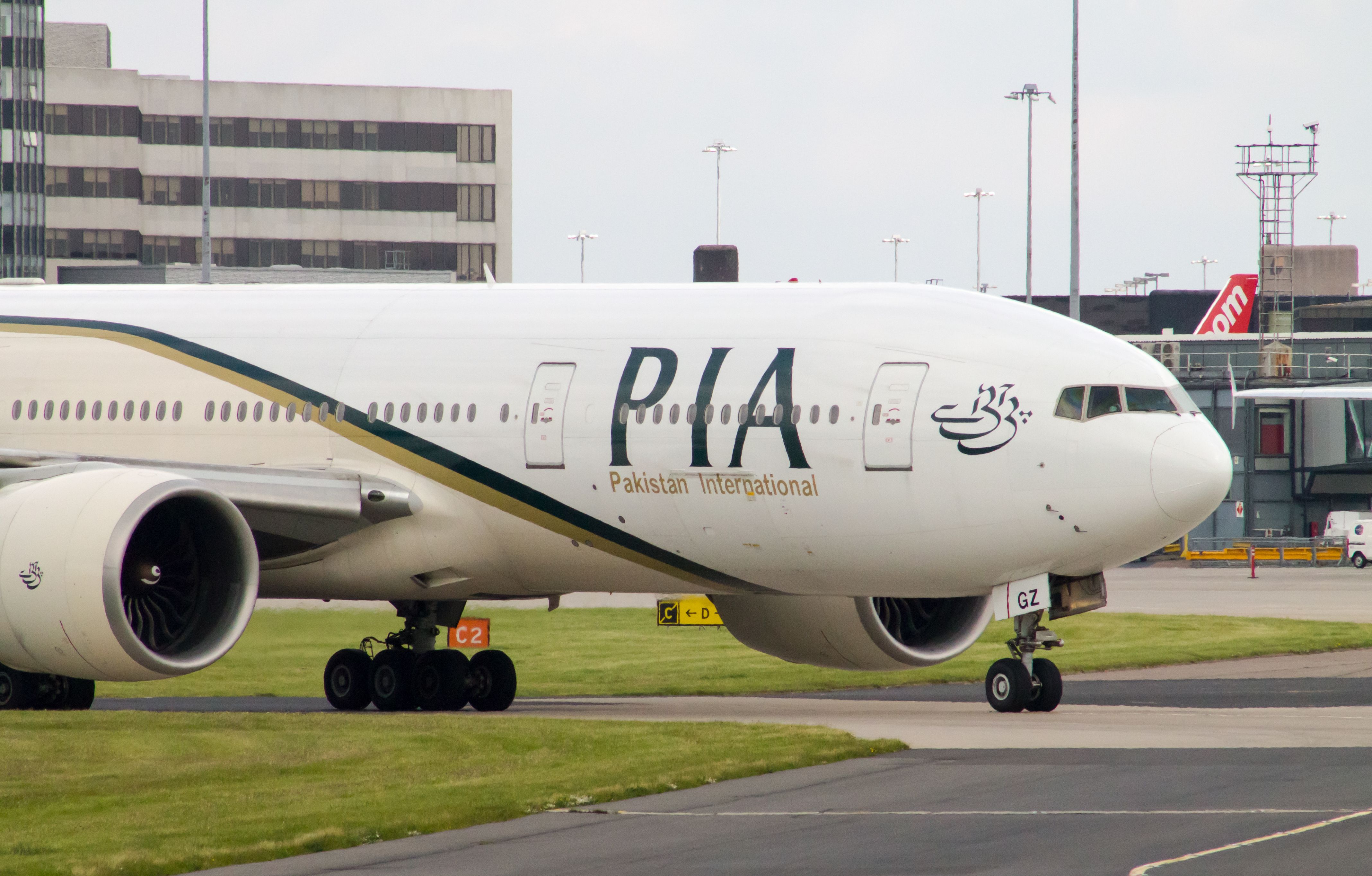 A Pakistan International Airlines Boeing 777 wide-body passenger plane taxiing on Manchester International Airport. 
