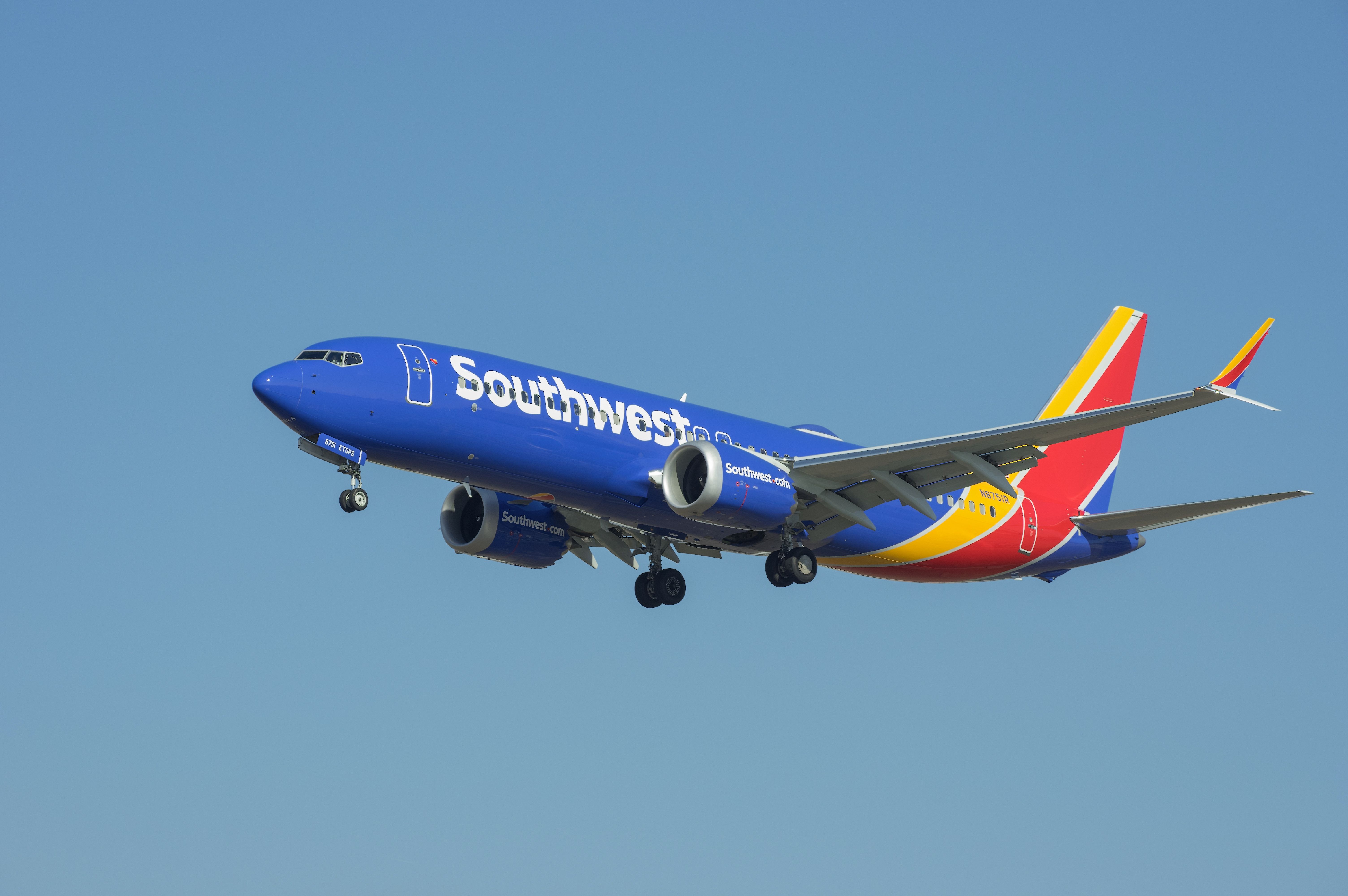 A Southwest Airlines Boeing 737 MAX 8 flying in the sky.