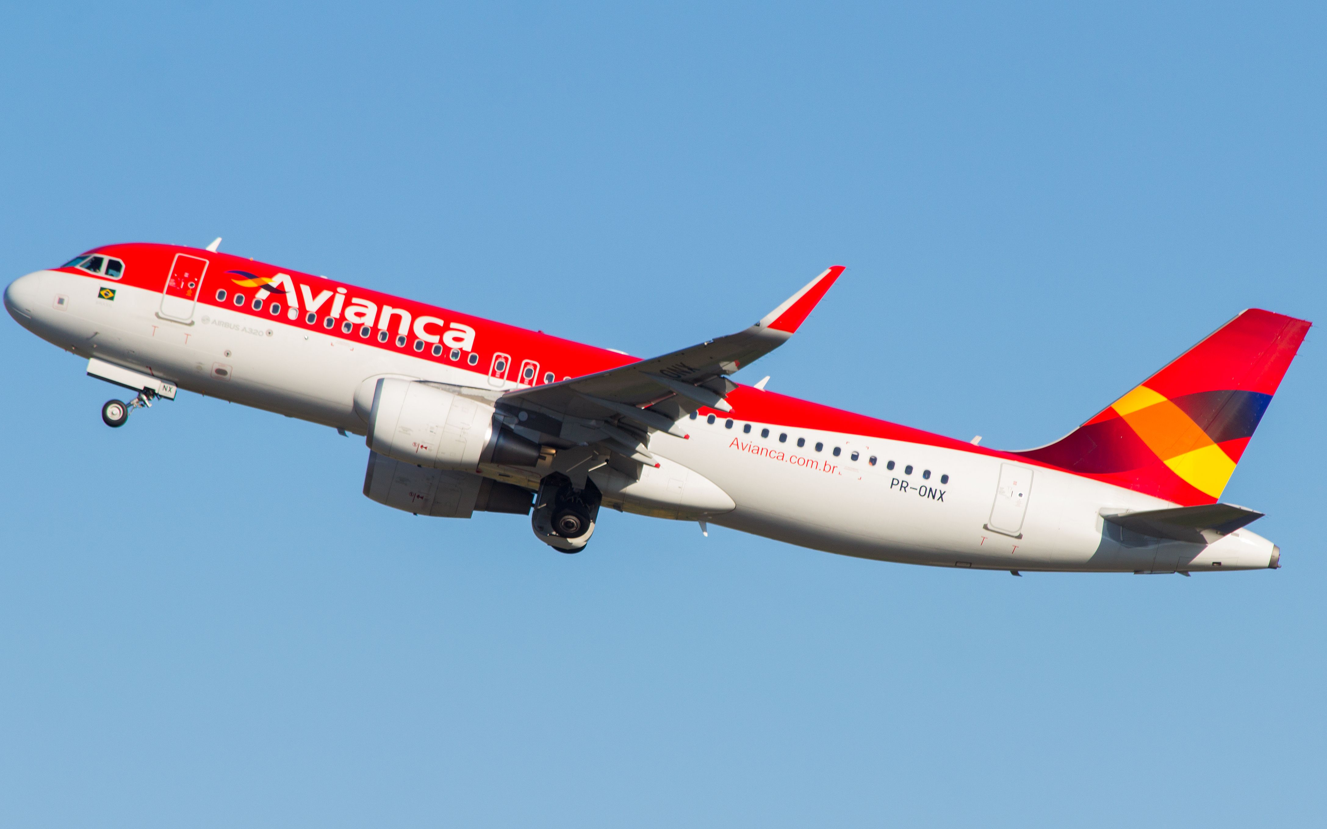 An Avianca Brasil Airbus A320ceo flying in the sky.