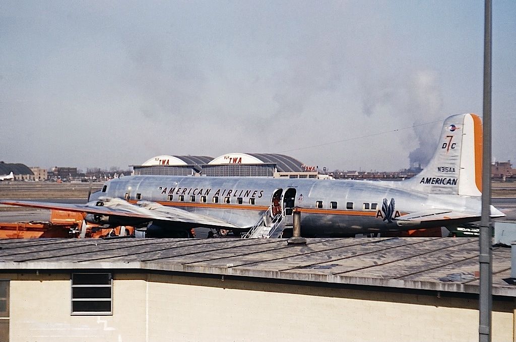 An American Airlines DC-7 parked at an airport.