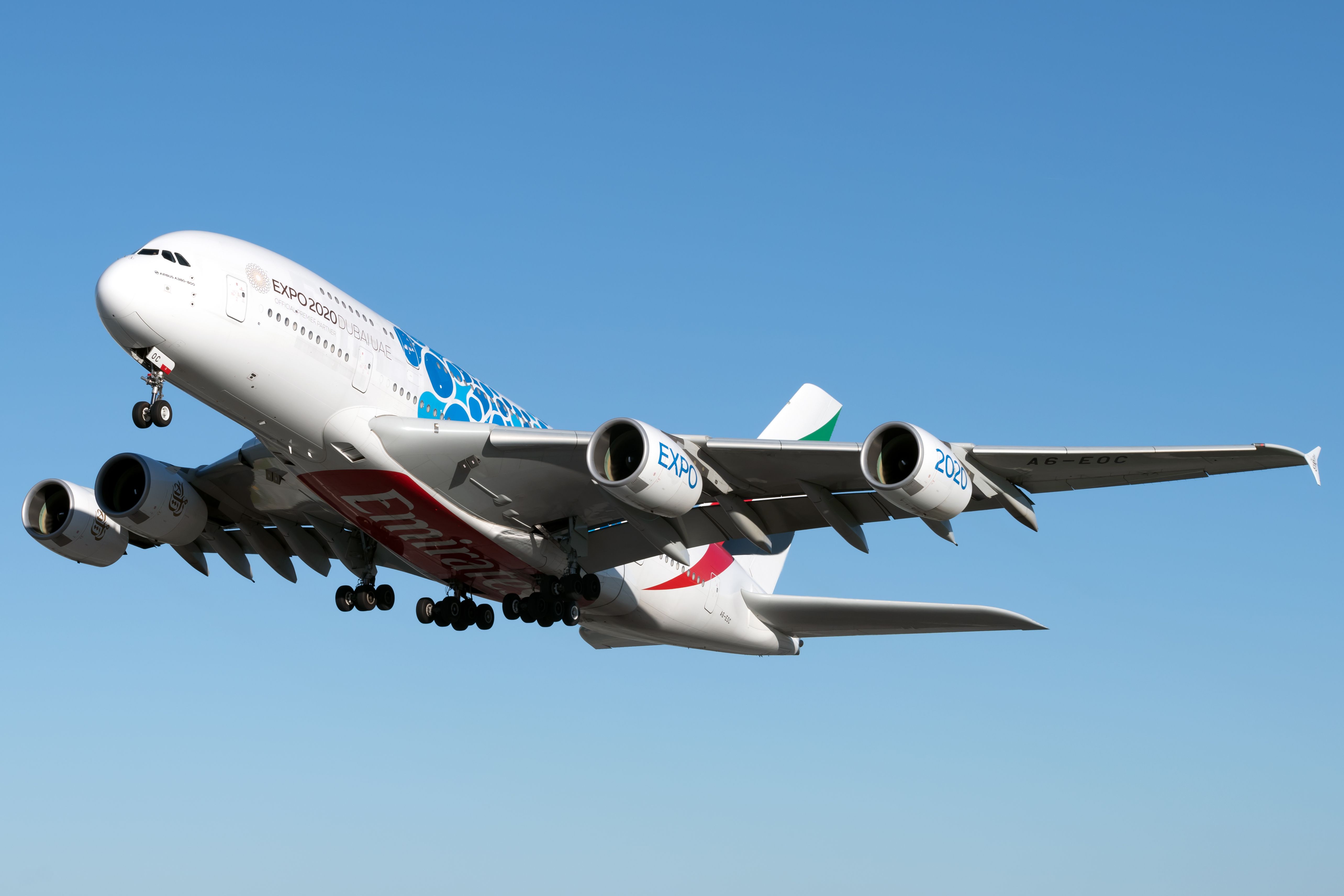 An Emirates Airbus A380 in Dubai Expo 2020 Mobility Livery flying in the sky.