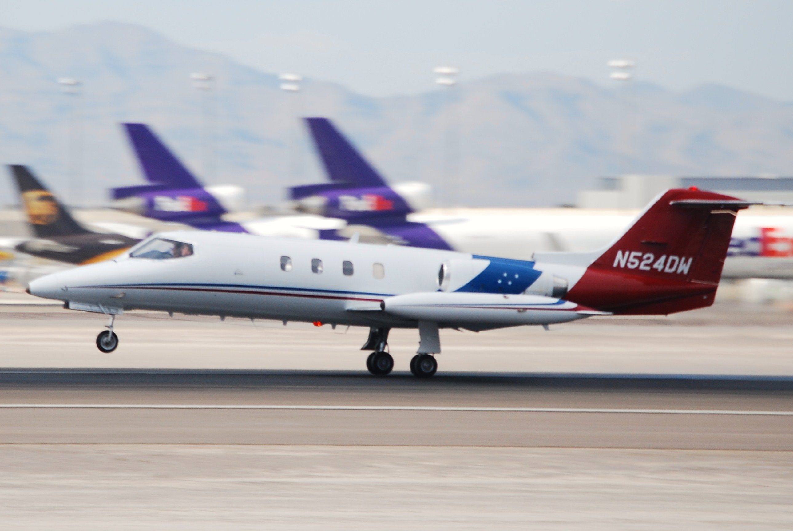 A Learjet 25 taking off from a runway.
