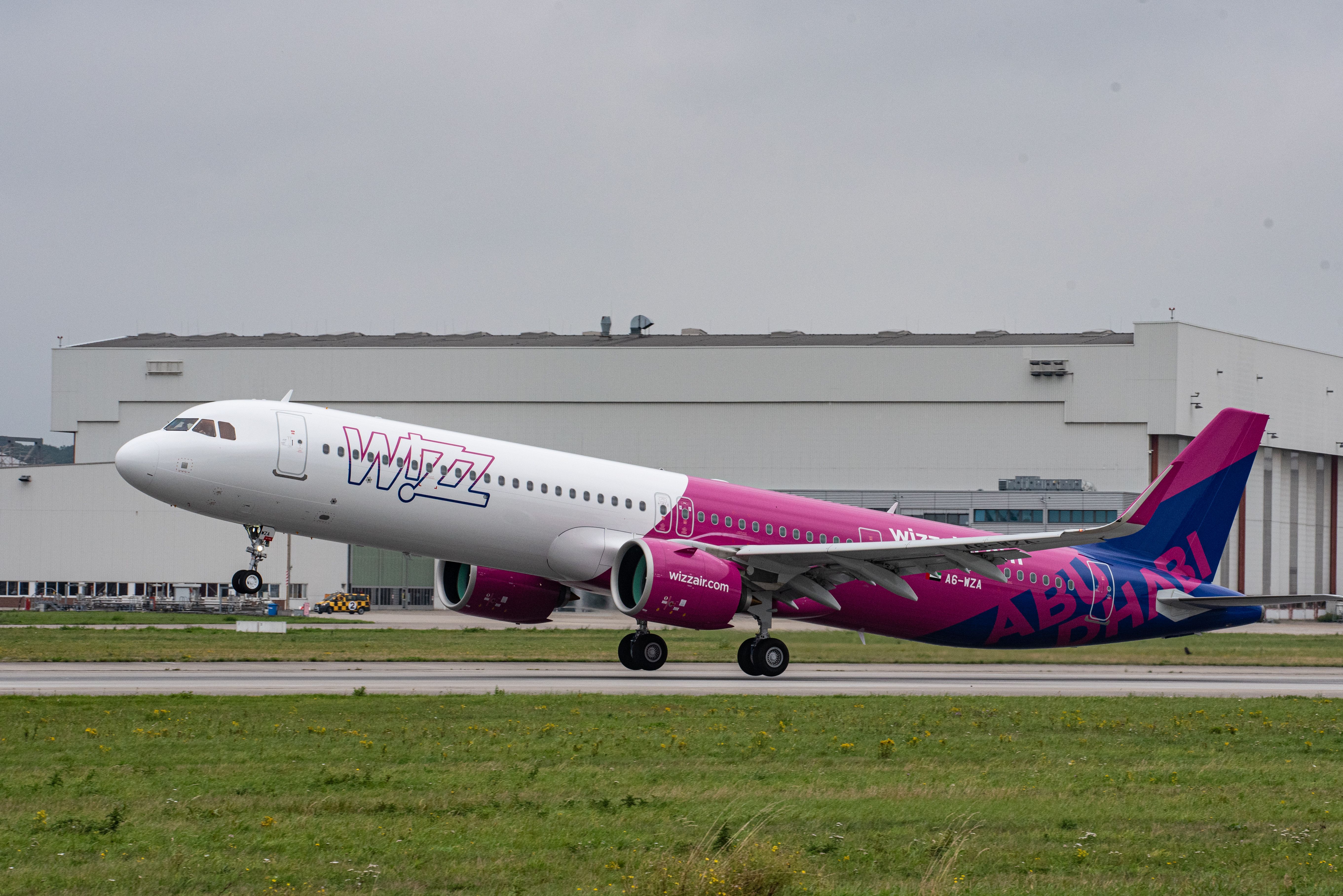 A Wizz Air Airbus A321neo taking off.