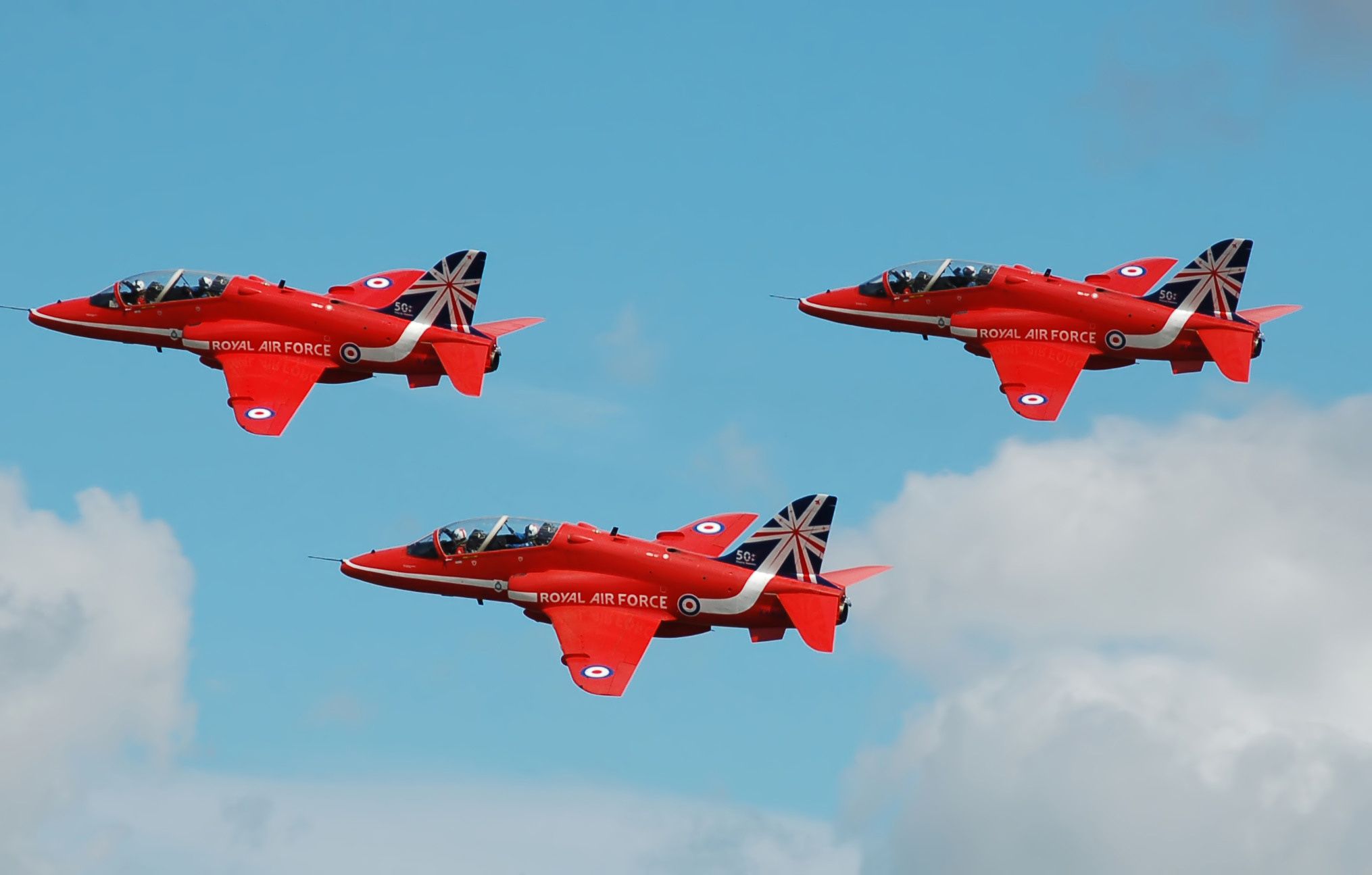 The RAF Red Arrows fly in the sky.