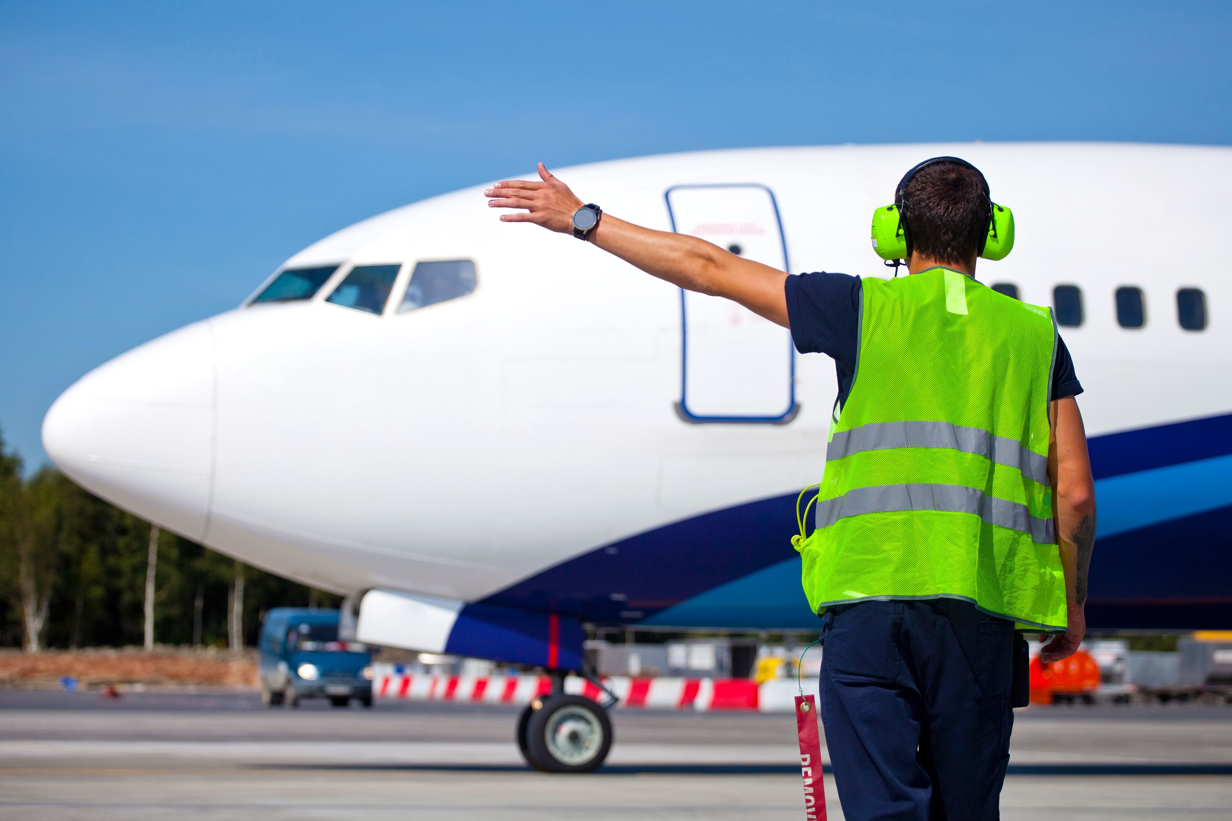 A marshaler waves off a Boeing 737. 