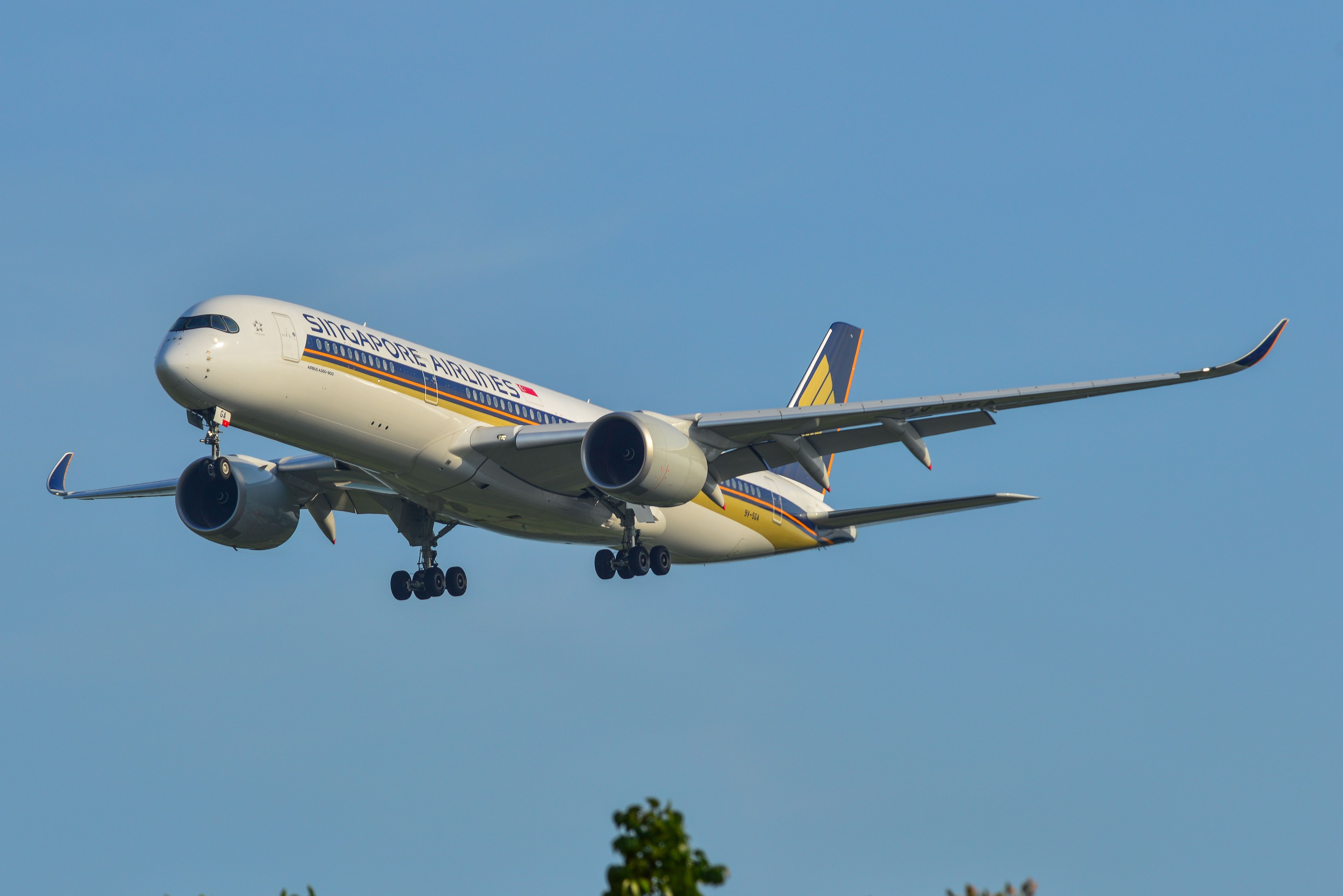 A Singapore Airlines Airbus A350-900ULR flying low to the ground.