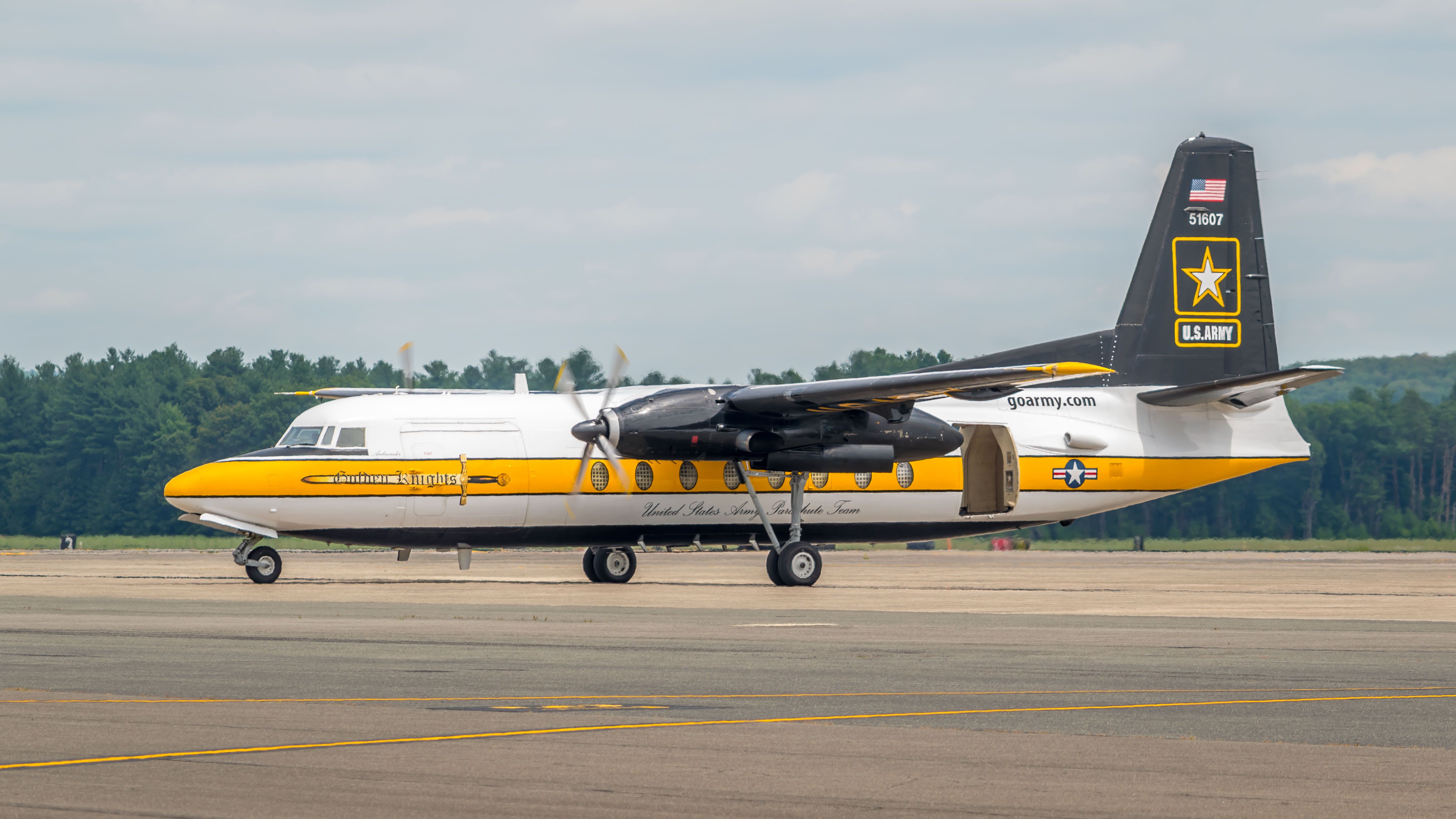 A US Army Parachute Team Fokker F27 parked at an airfield.