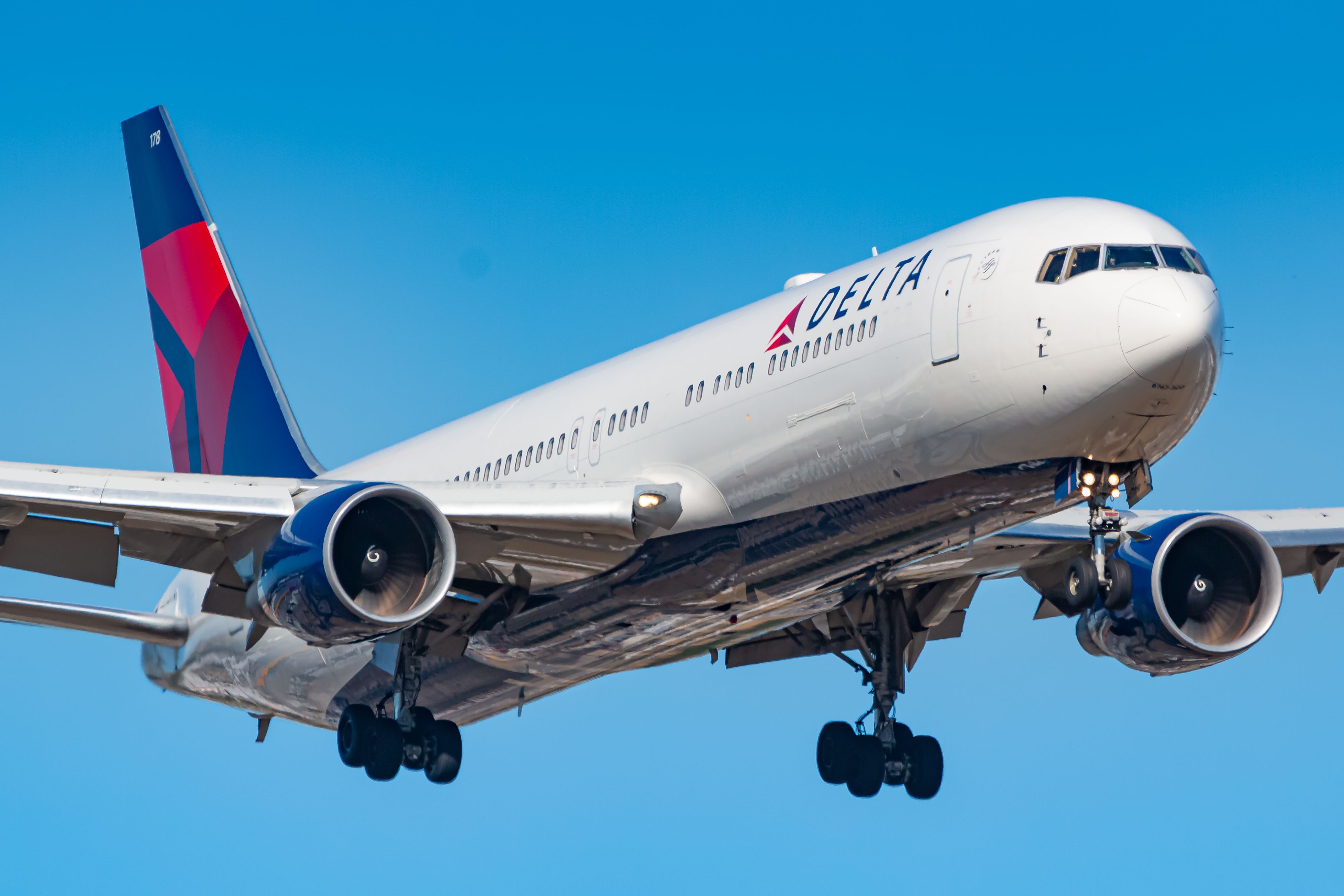 A Delta Air Lines Boeing 767 flying in the sky.