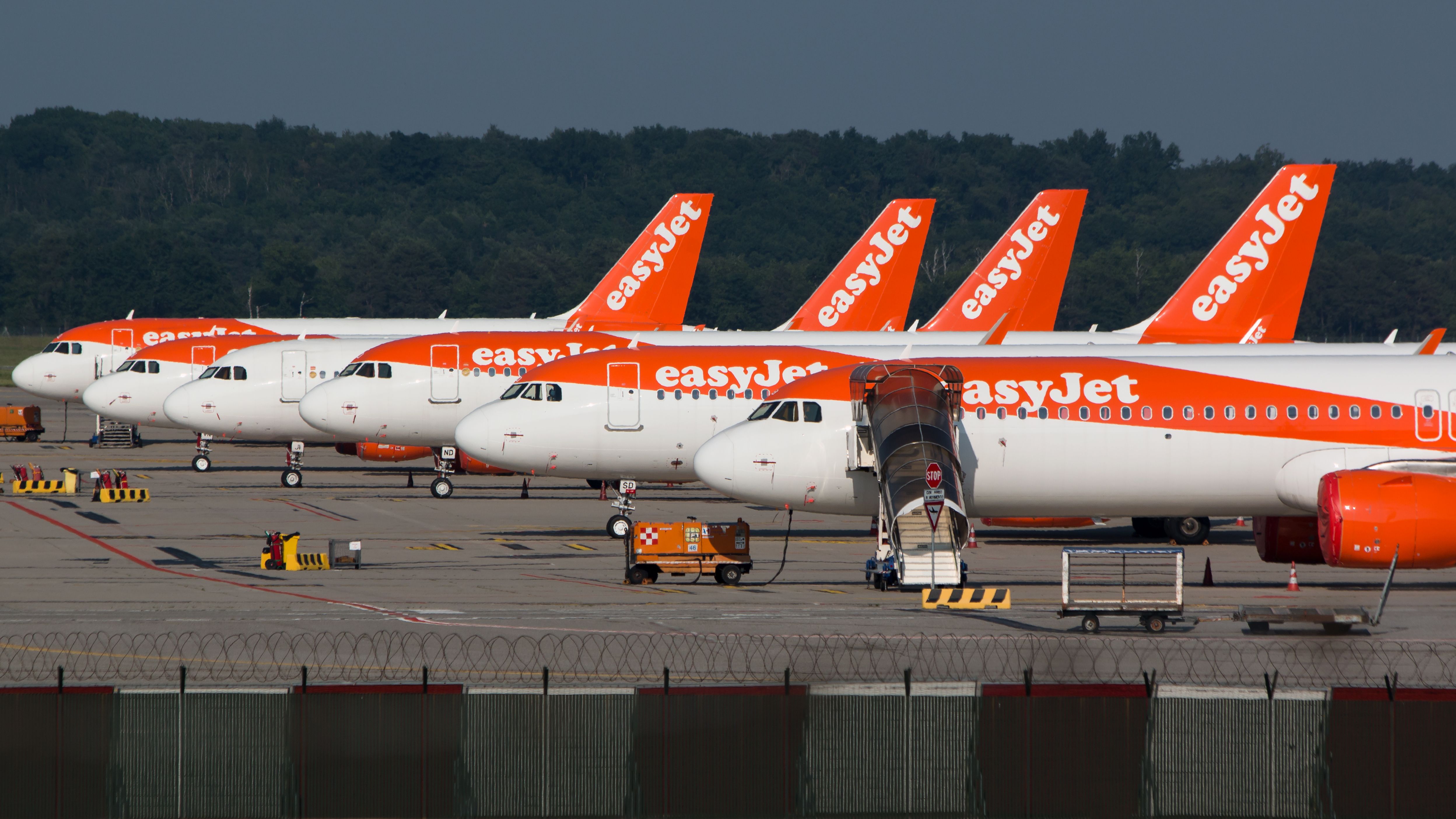 Several easyJet Planes Lined Up on the apron.