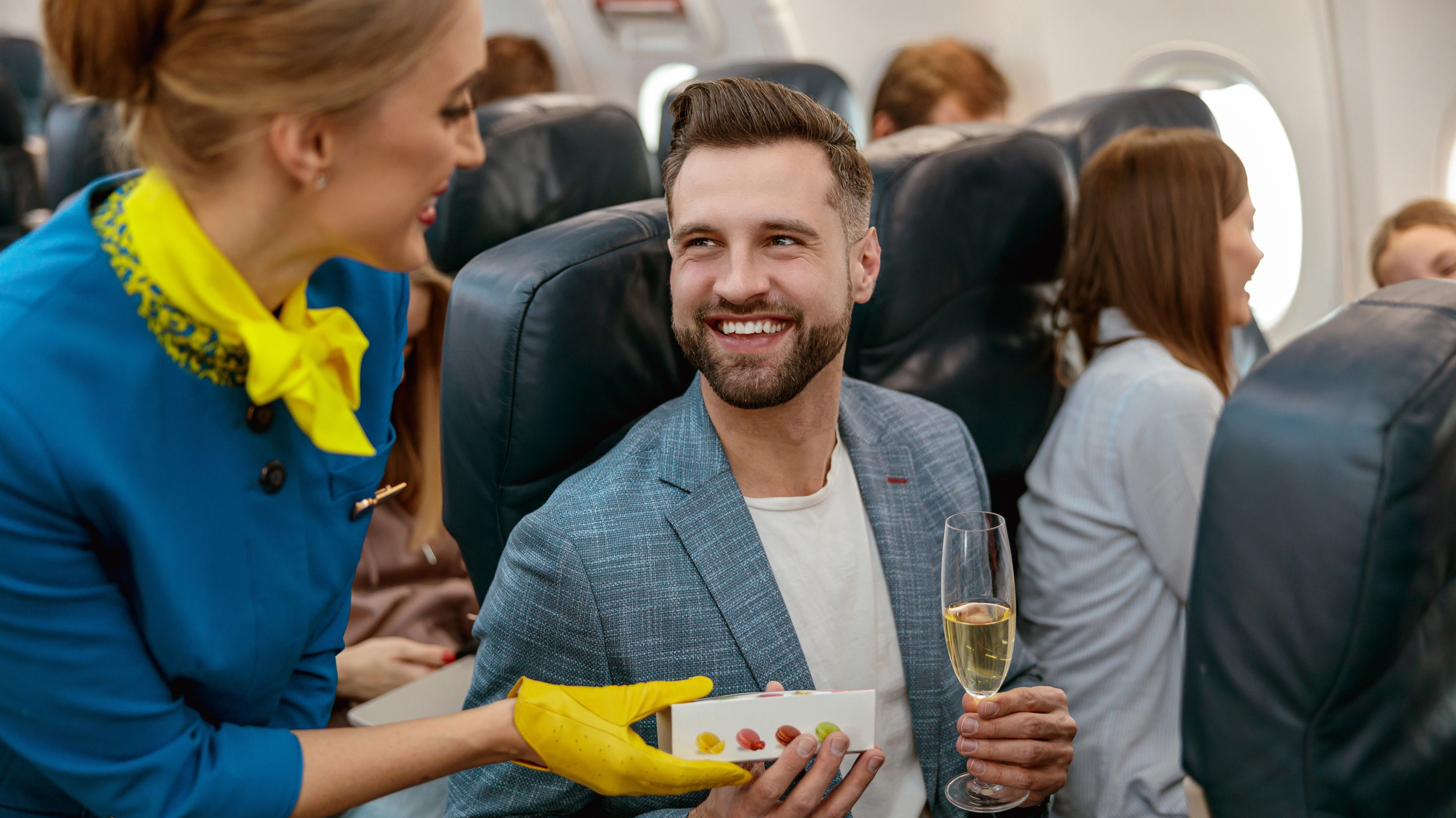 Flight Attendant Giving Passenger Food & Drink