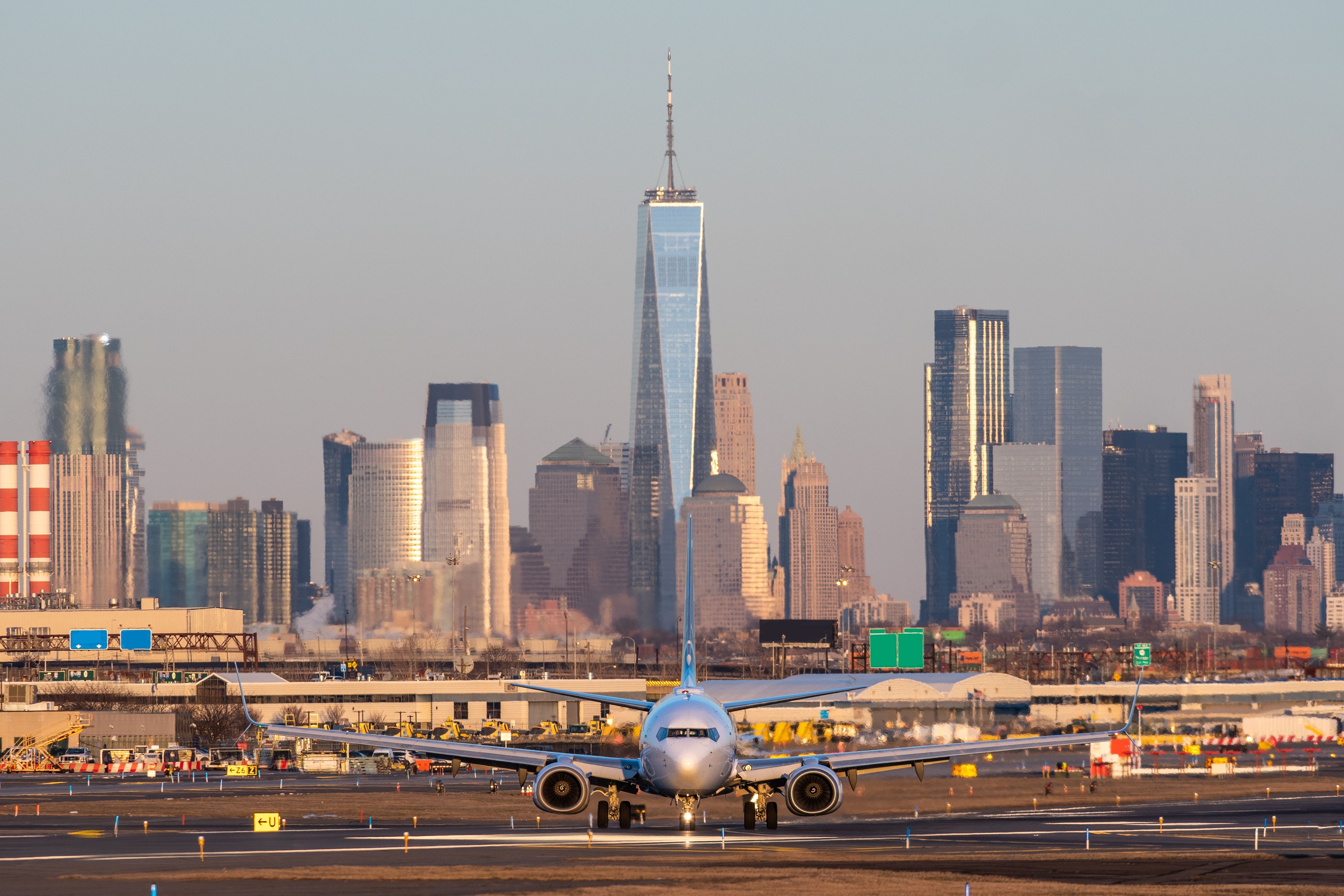 A 737 taxiing at Newark Liberty International Airport with the Manhattan skyline in the background.