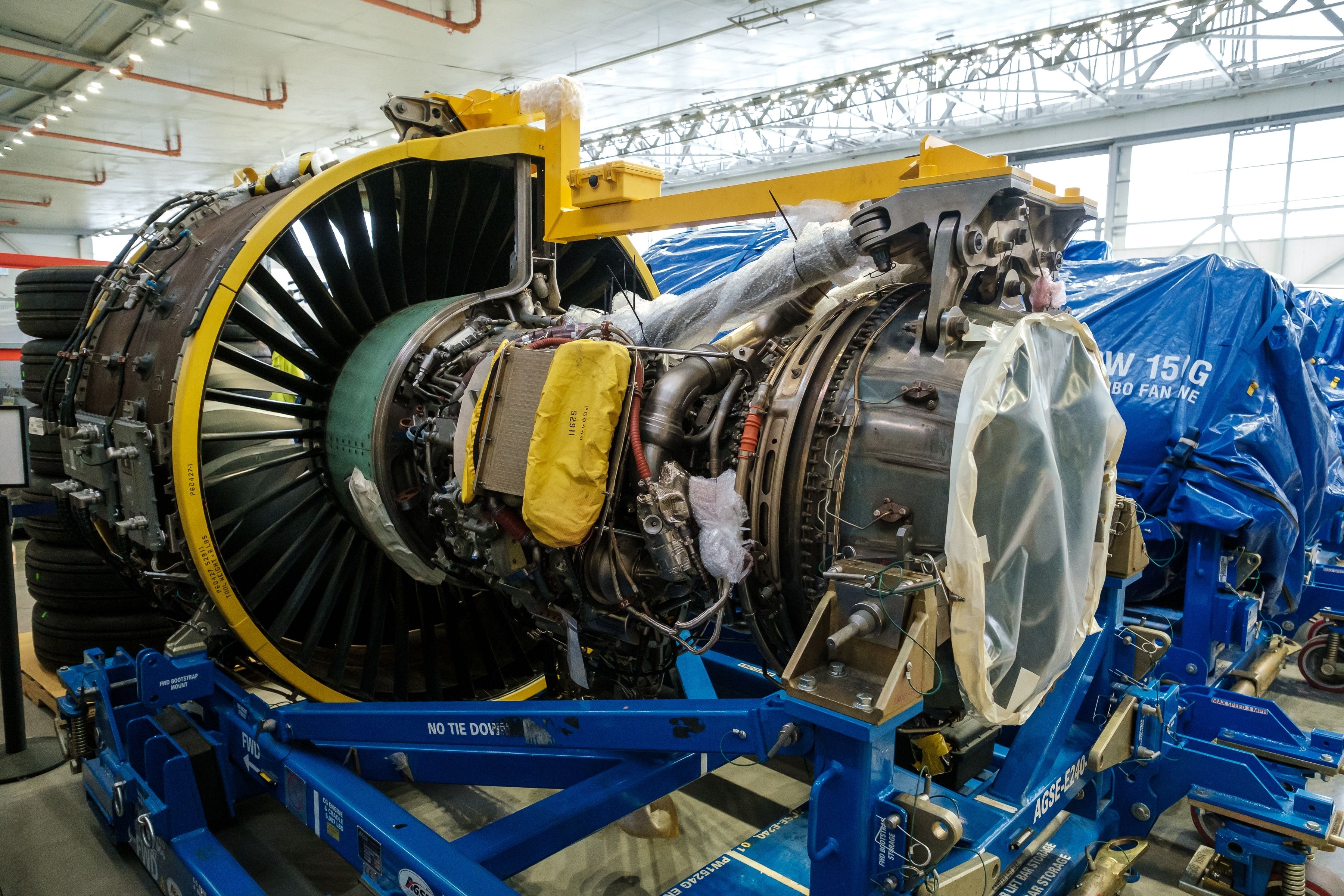 A partially disassembled Pratt Whitney PW1500G engine of an Airbaltic Airbus A220 displayed during a press event.