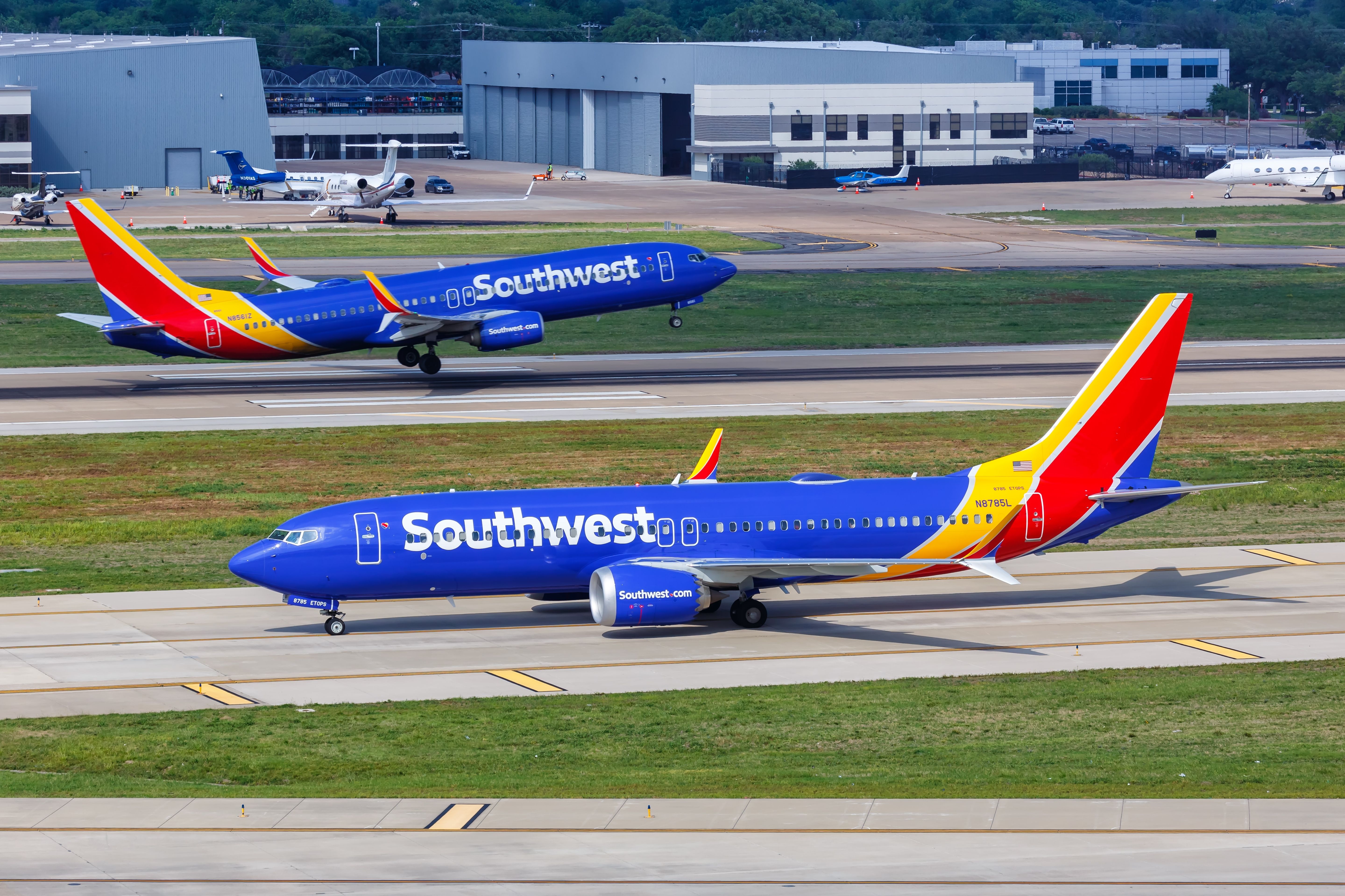Two Southwest Airlines Boeing 737s, one taxiing and the other taking off.