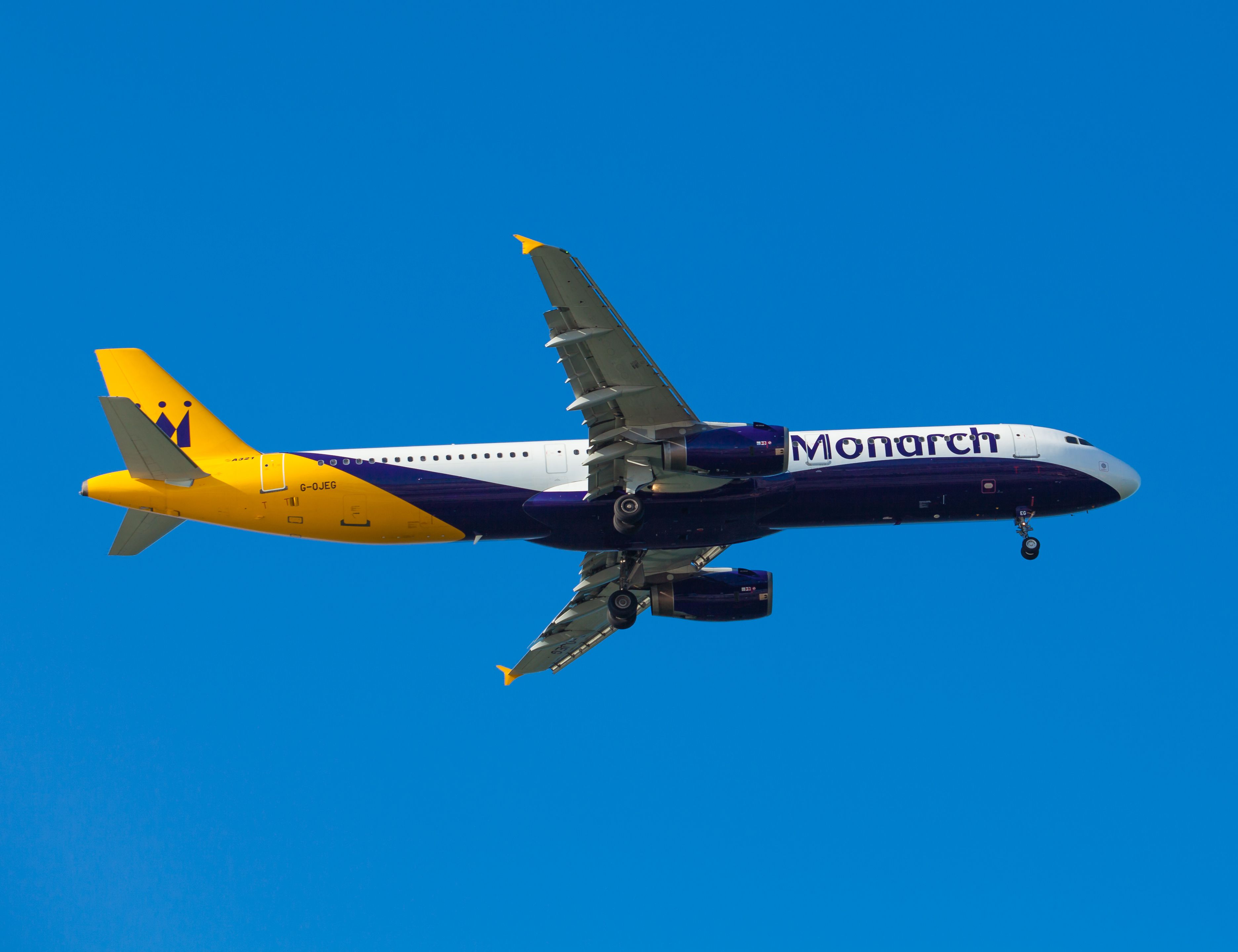 A Monarch aircraft flying in the sky.