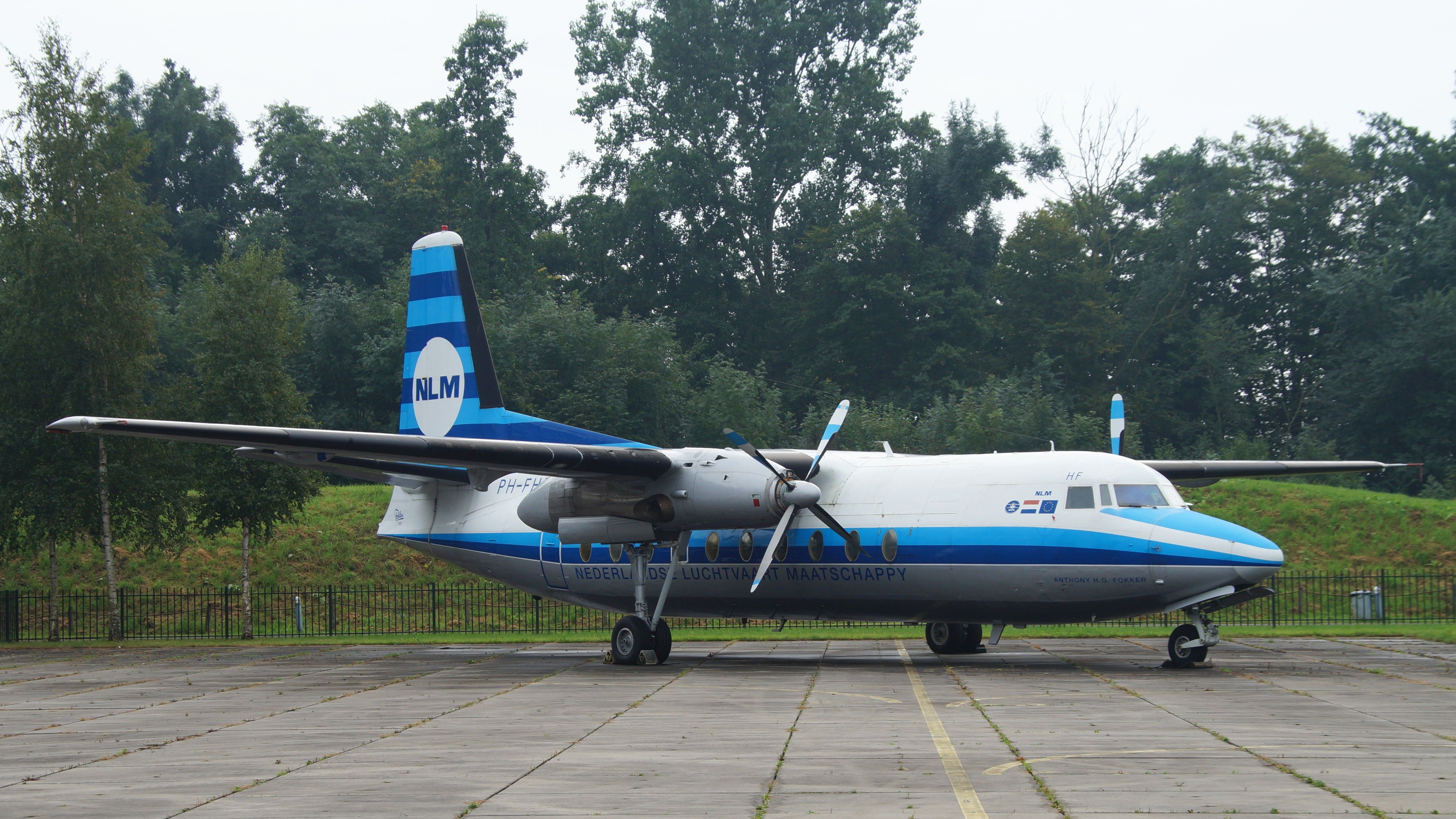 An NLM Fokker F27 Parked at an airport.