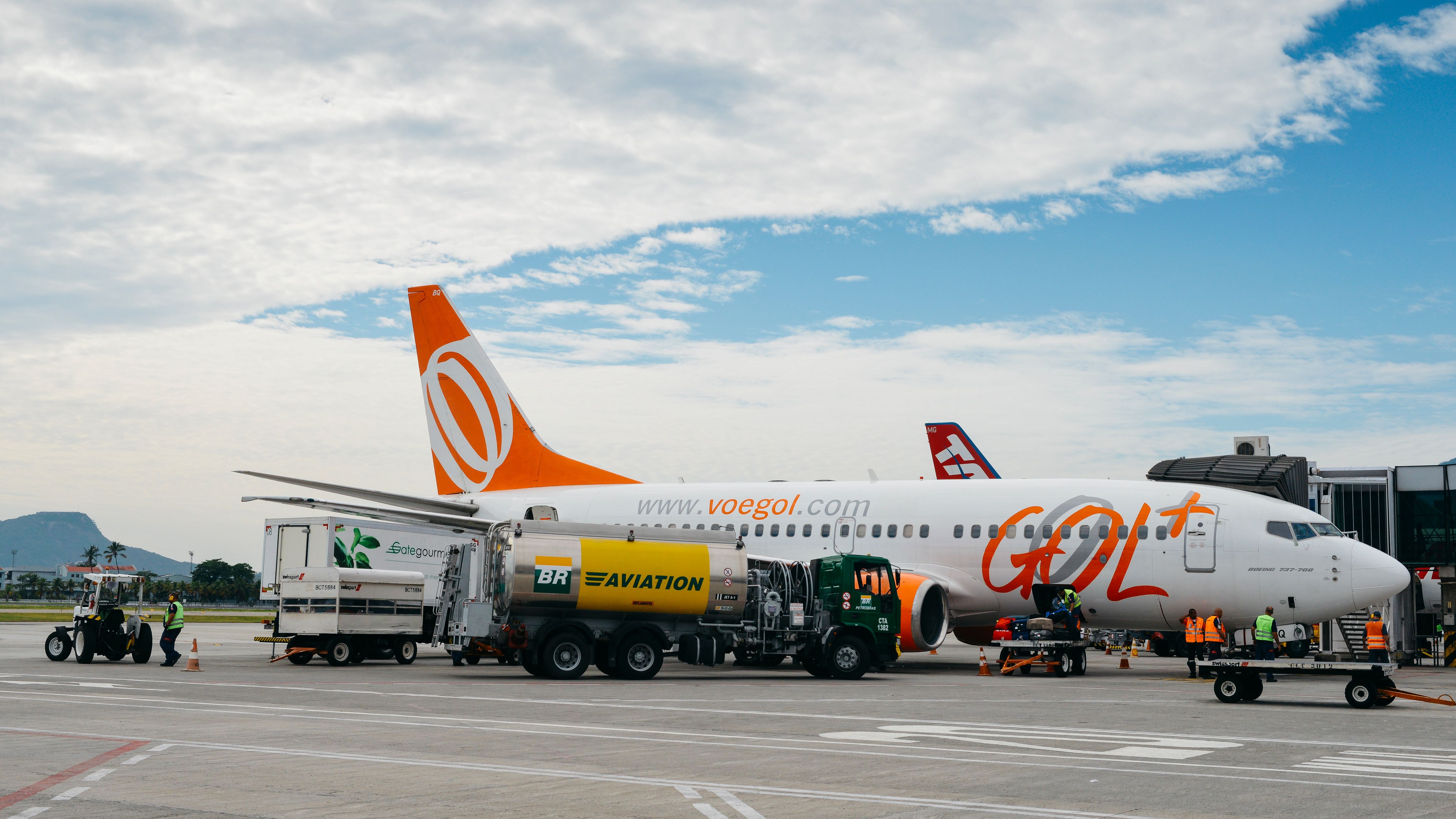 shutterstock_781322974 - Santos Dumont Airport, Rio de Janeiro, Brazil - Dec 22, 2017: Airport workers at Rio de Janeiro's Santos Dumont Airport carry out duties on a Gol airliner airplane