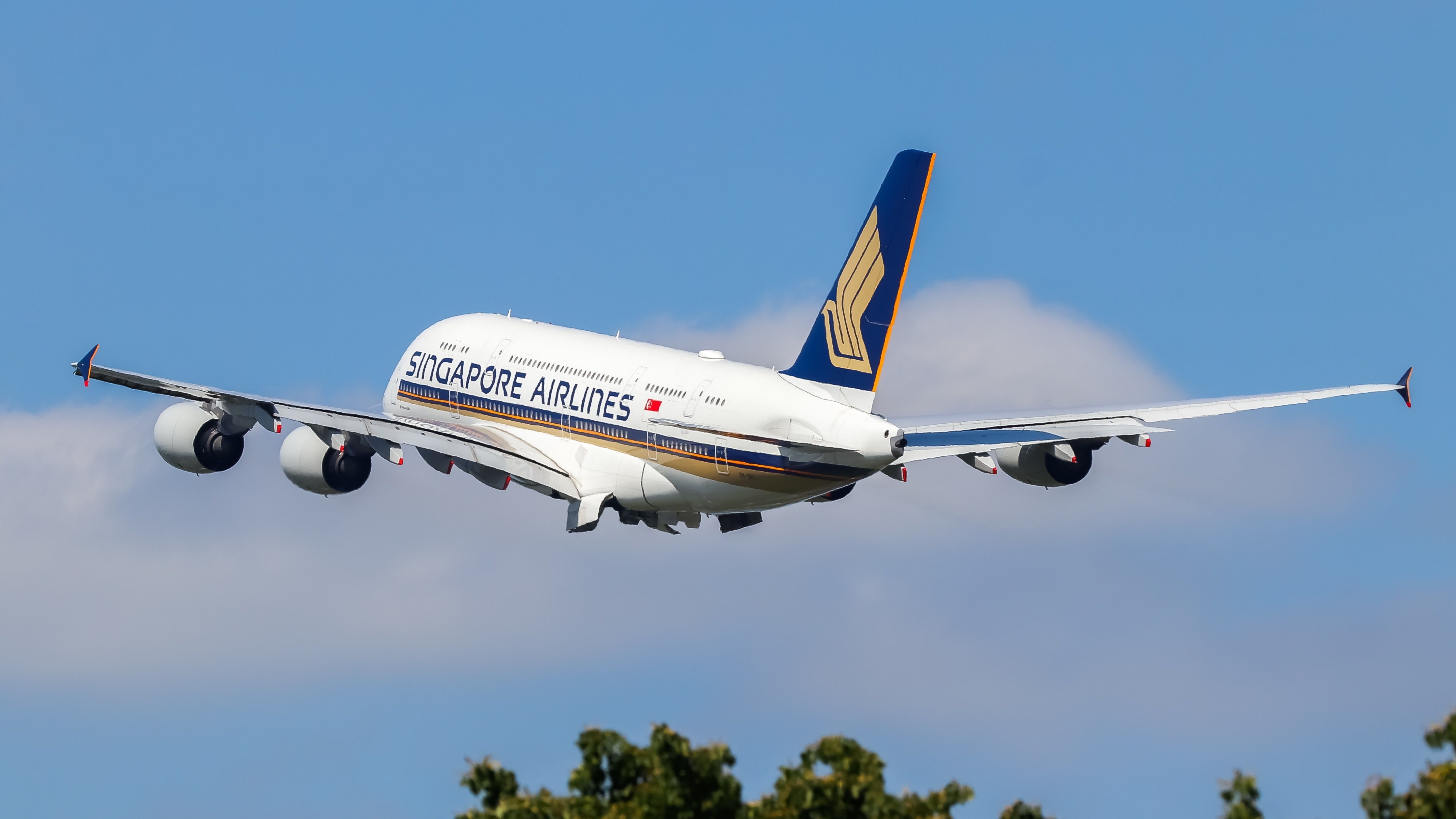 A Singapore Airlines Airbus A380 taking off into the sky.