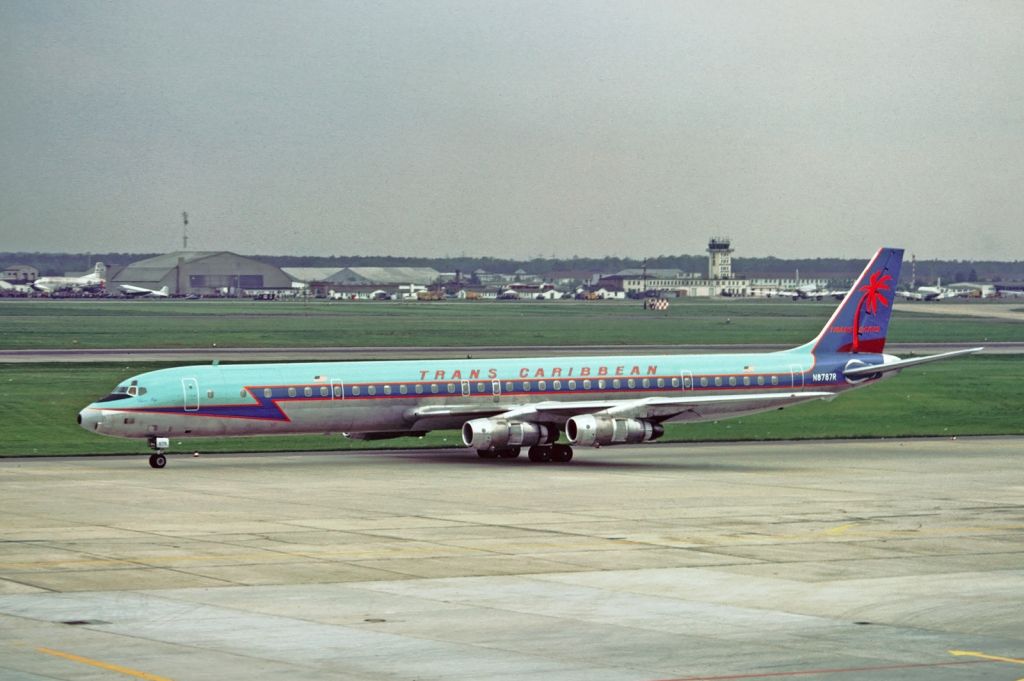 A Trans Caribbean Airways DC-8 taxiing to the airport gate.