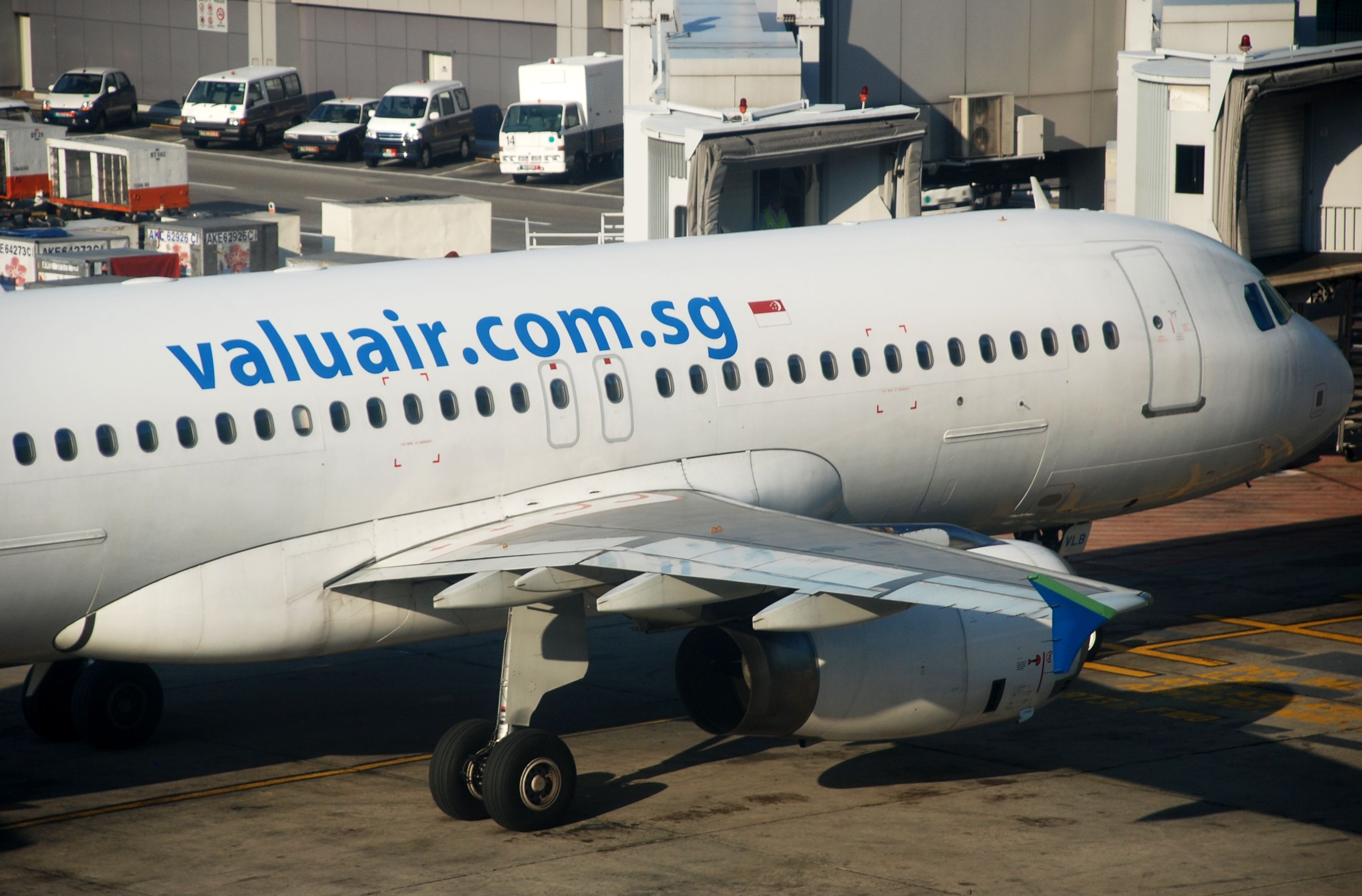 A Valuair Airbus A320 parked at the gate.