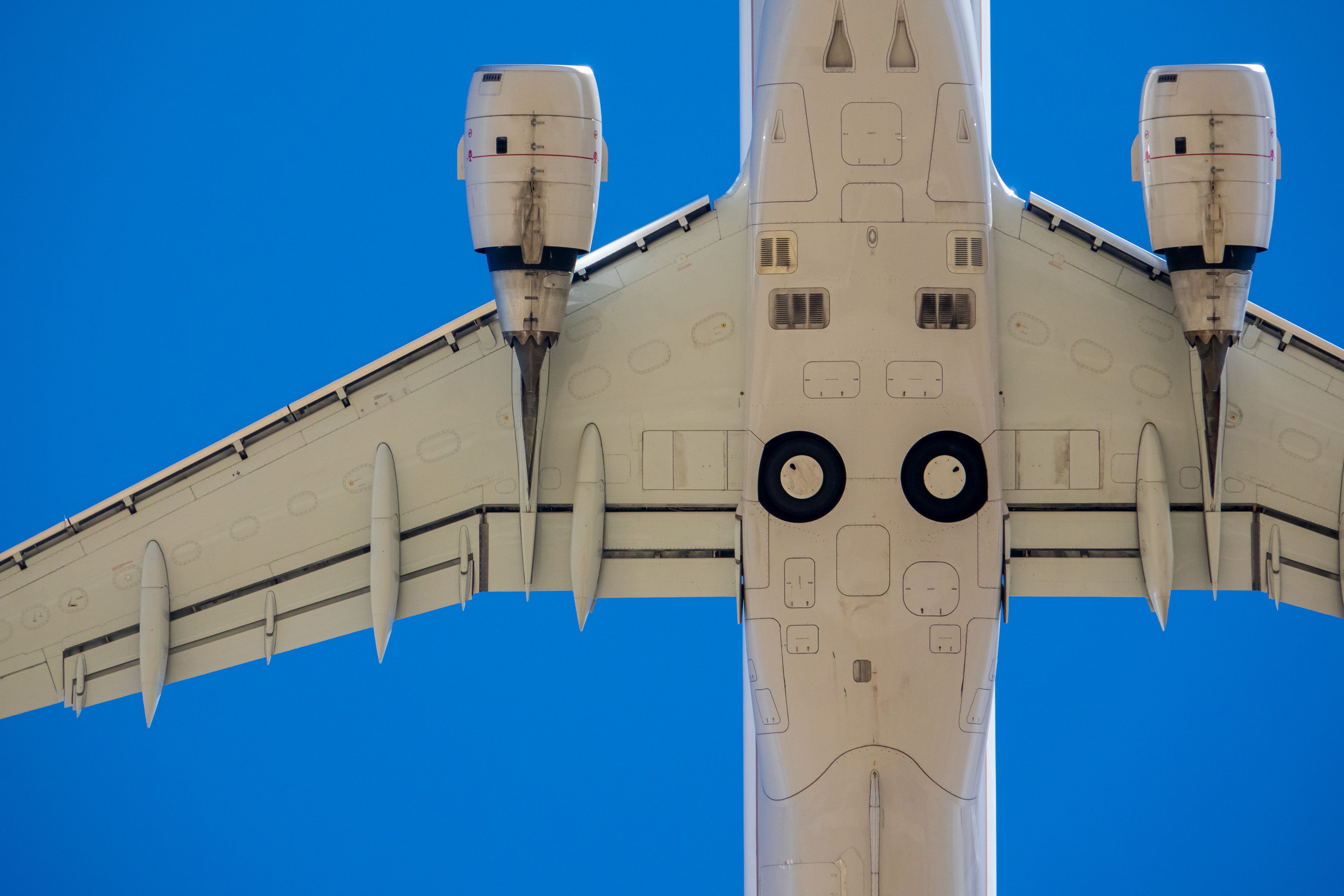 A closeup of an aircraft flying overhead.