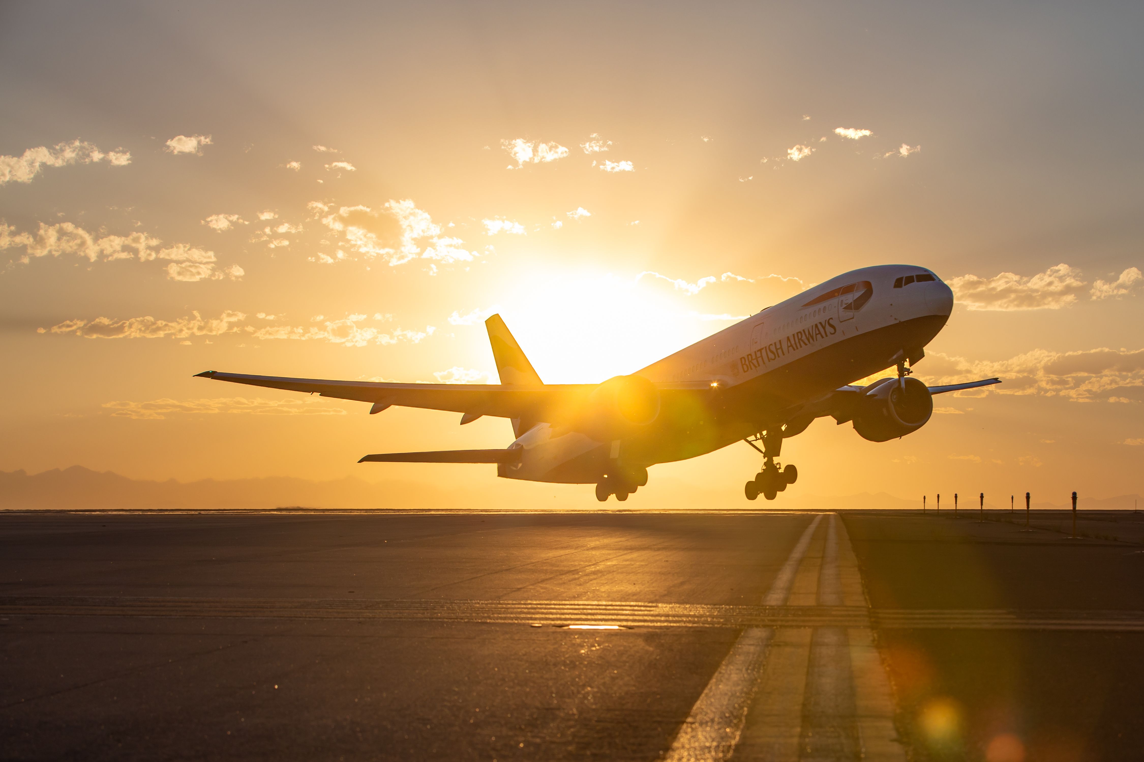 A British Airways plane takes off at dusk.