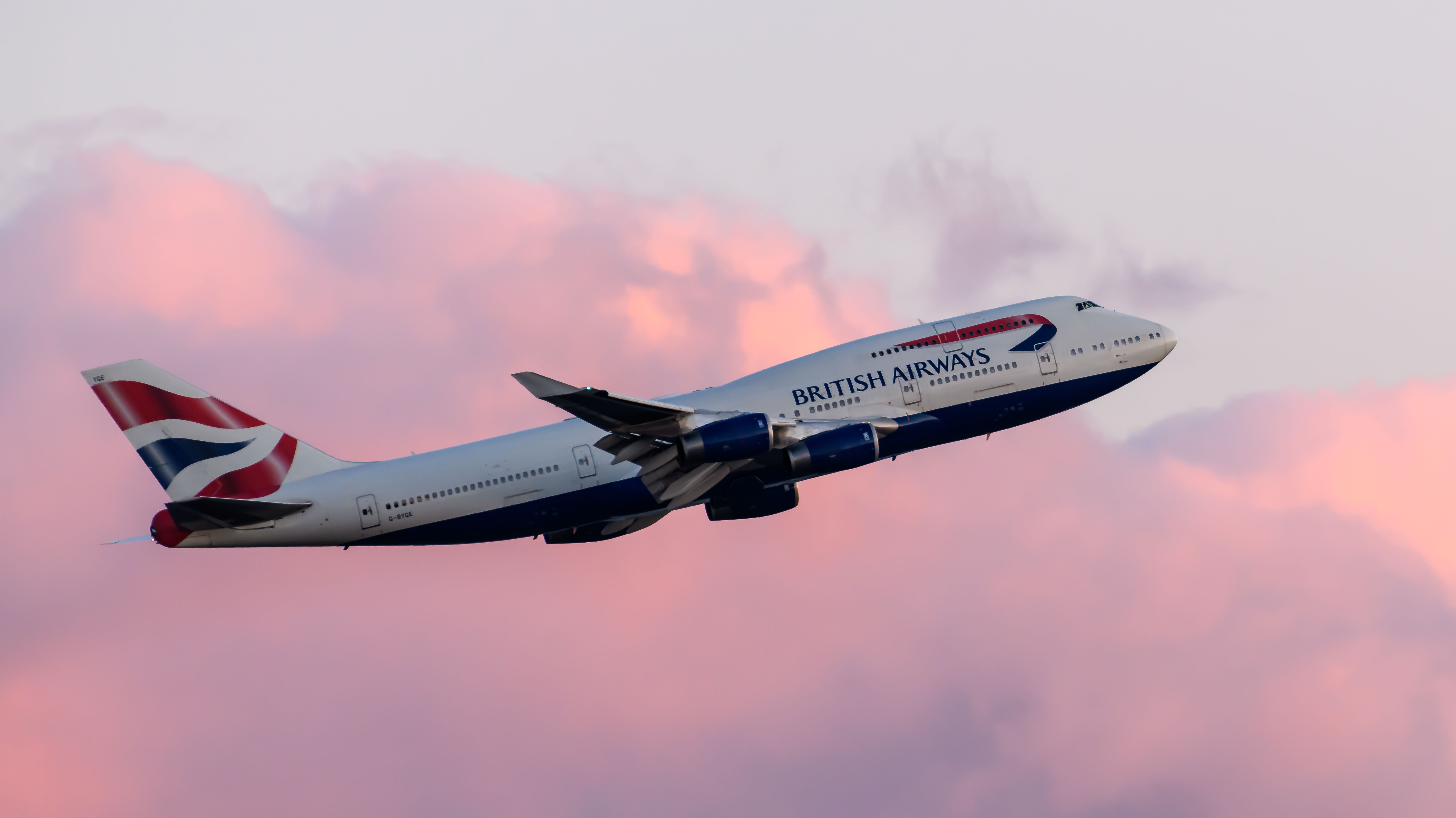 A British Airways Boeing 747 taking off at sunset.