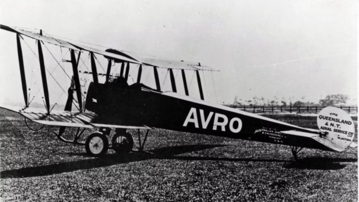A Qantas Avro aircraft parked on a field.
