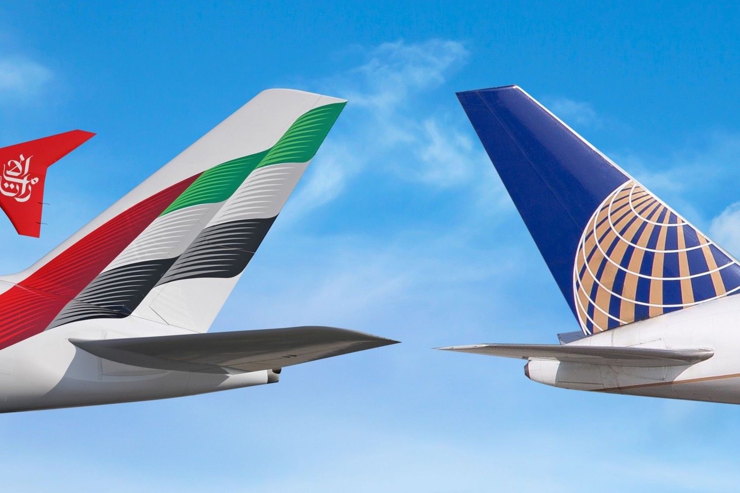 The tails of an Emirates and United Airlines aircraft side by side.
