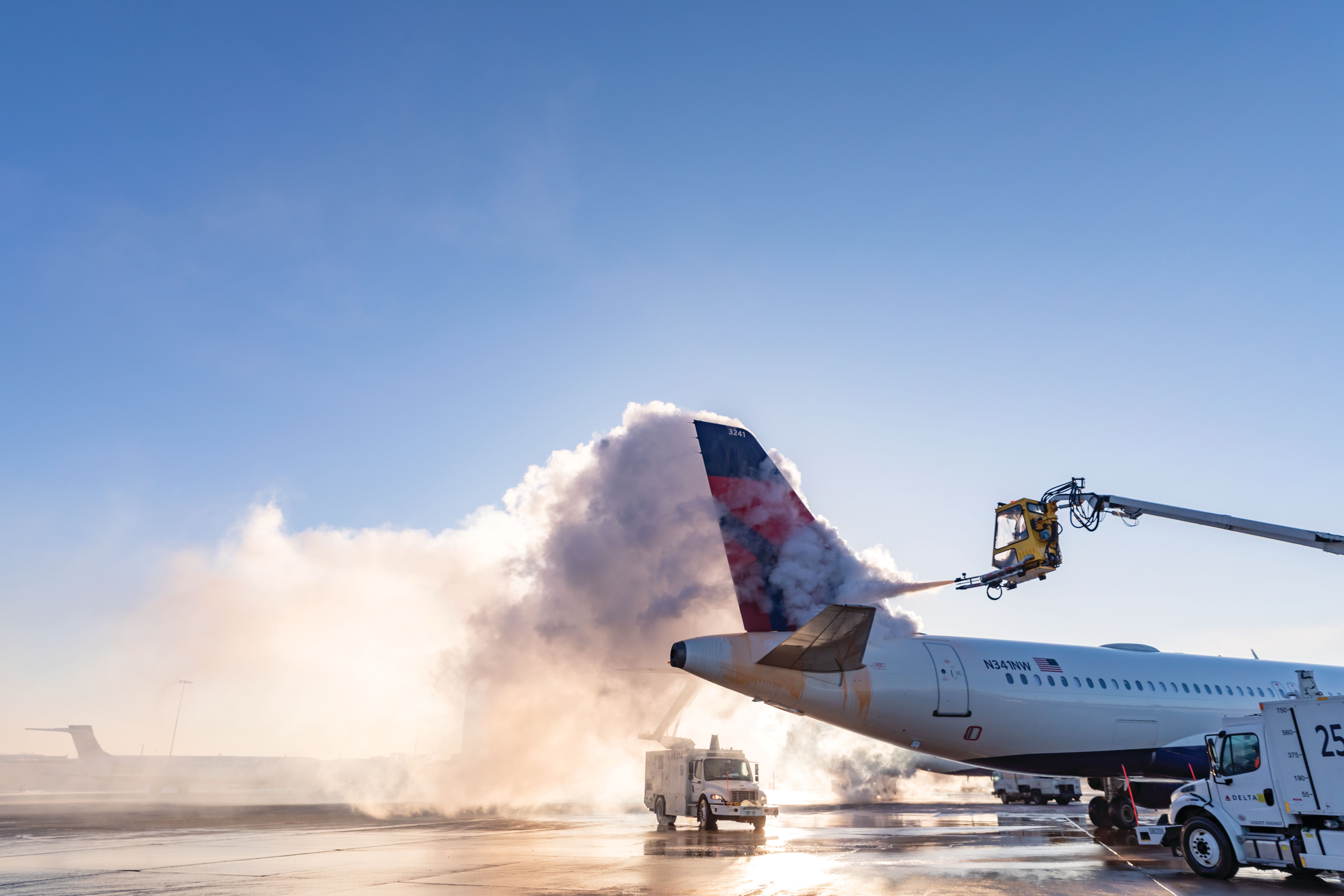 Delta Air Lines' crews deicing an aircraft.