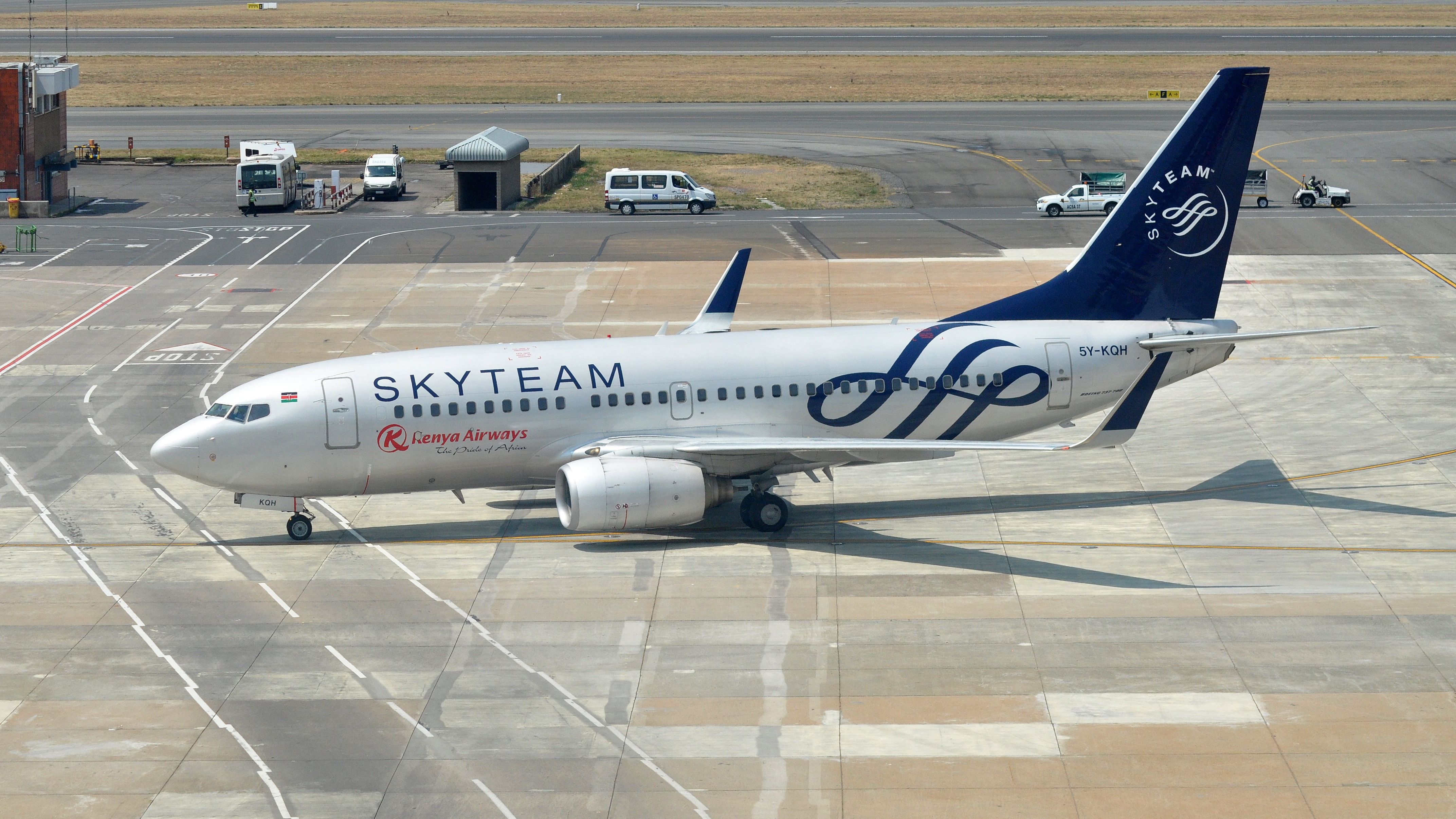 A Kenya Airways Boeing 737 in SkyTeam livery taxiing at an airport.