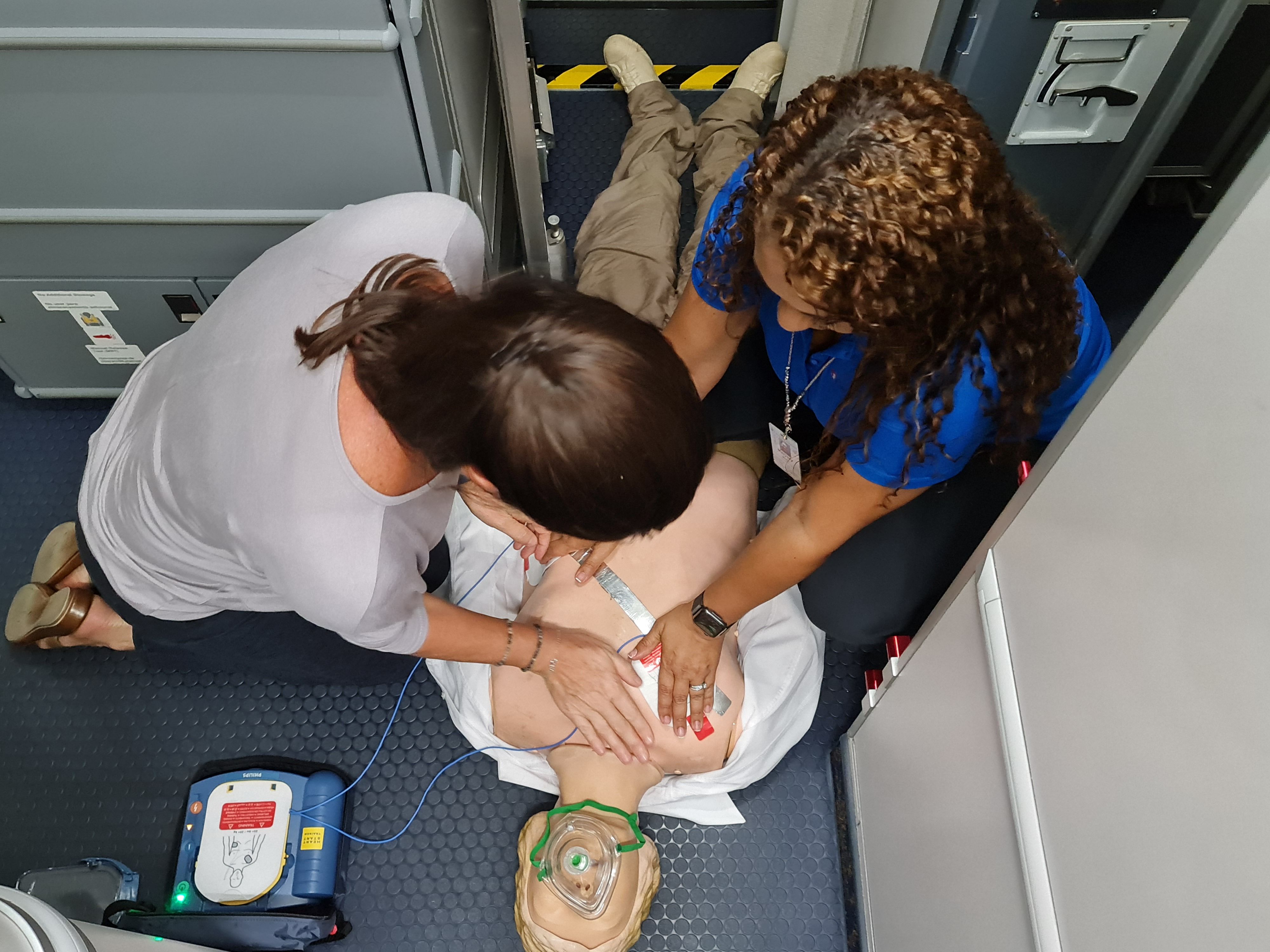 Cabin crew being trained on using a defibrilator.