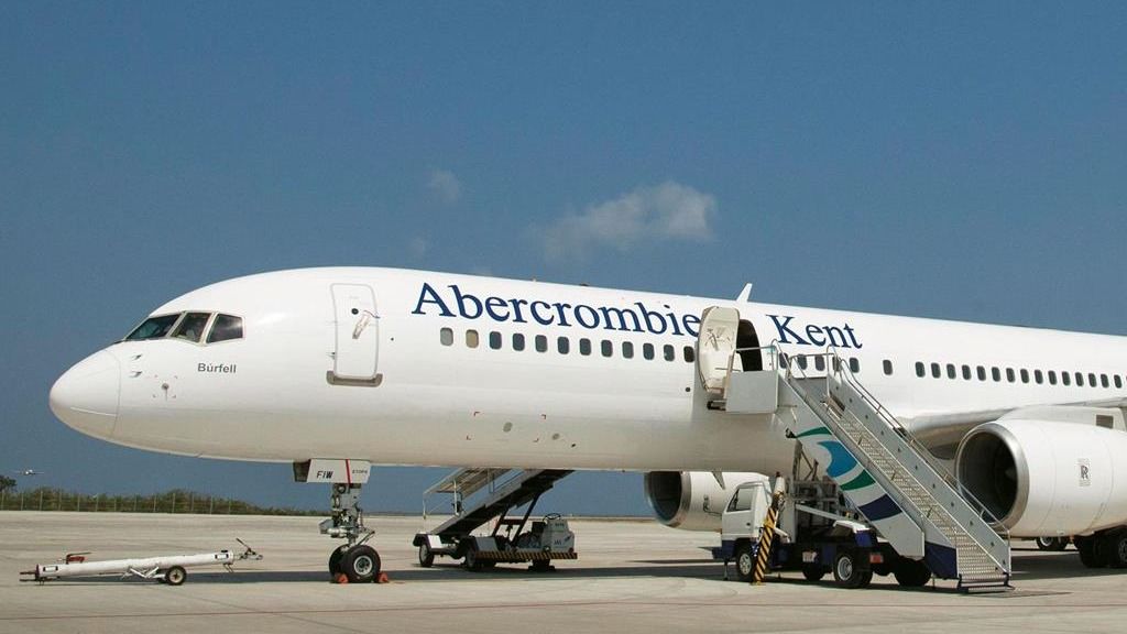The Abercrombie and Kent Boeing 757 parked at an airport.