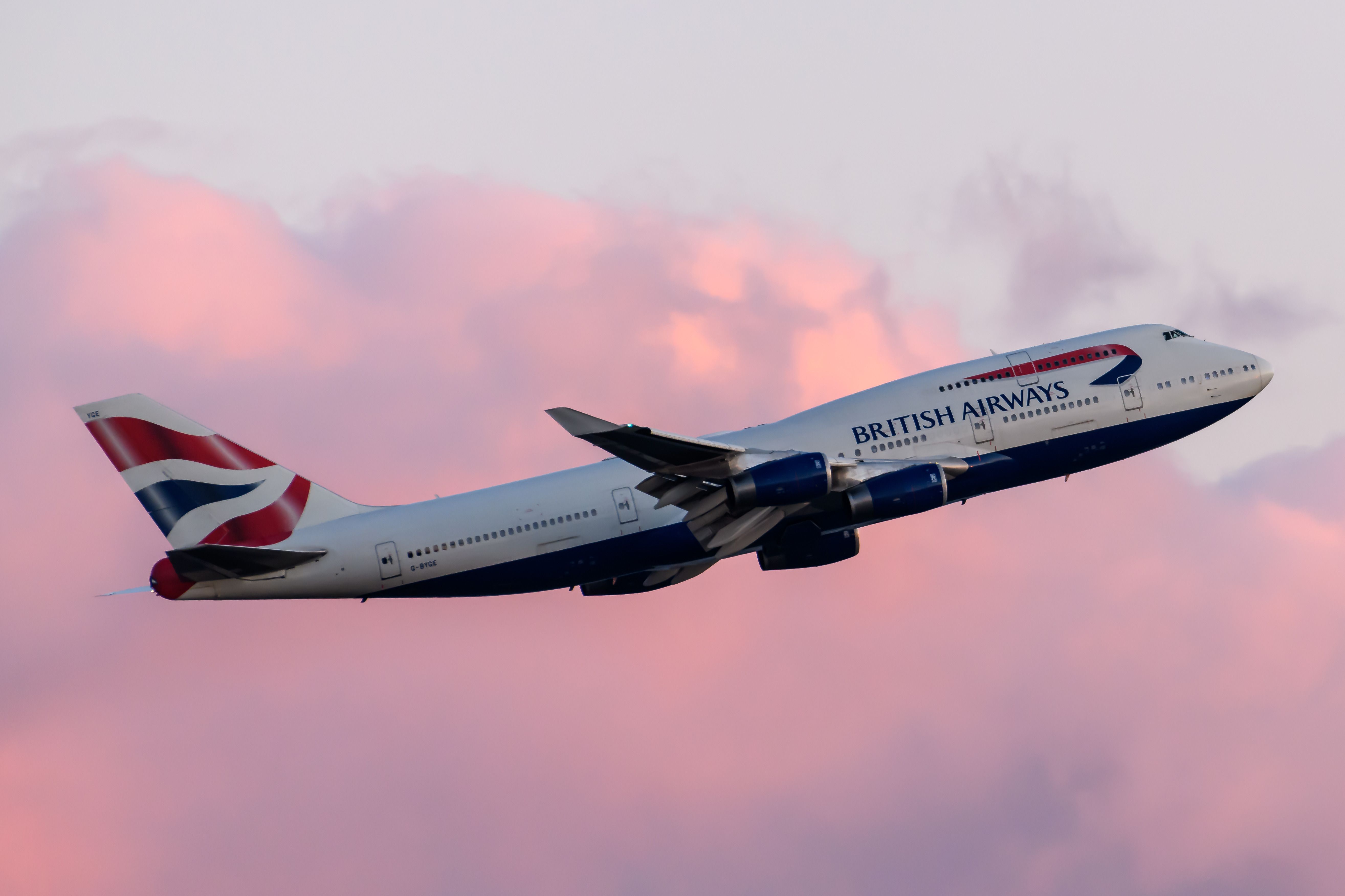 A British Airways Boeing 747 taking off at sunset.