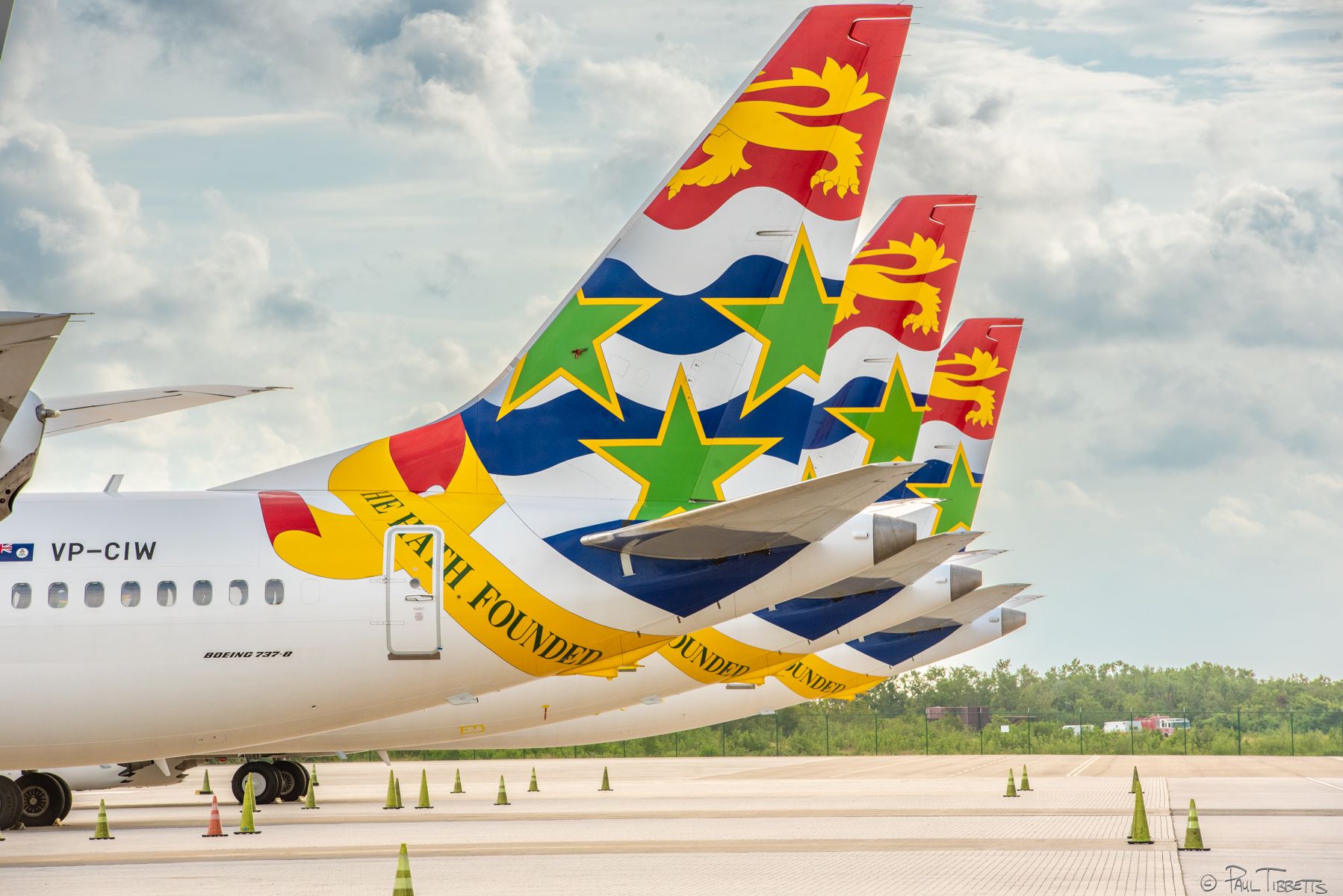 Several Cayman Airways Boeing 737 MAX 8 aircraft parked at an airport.